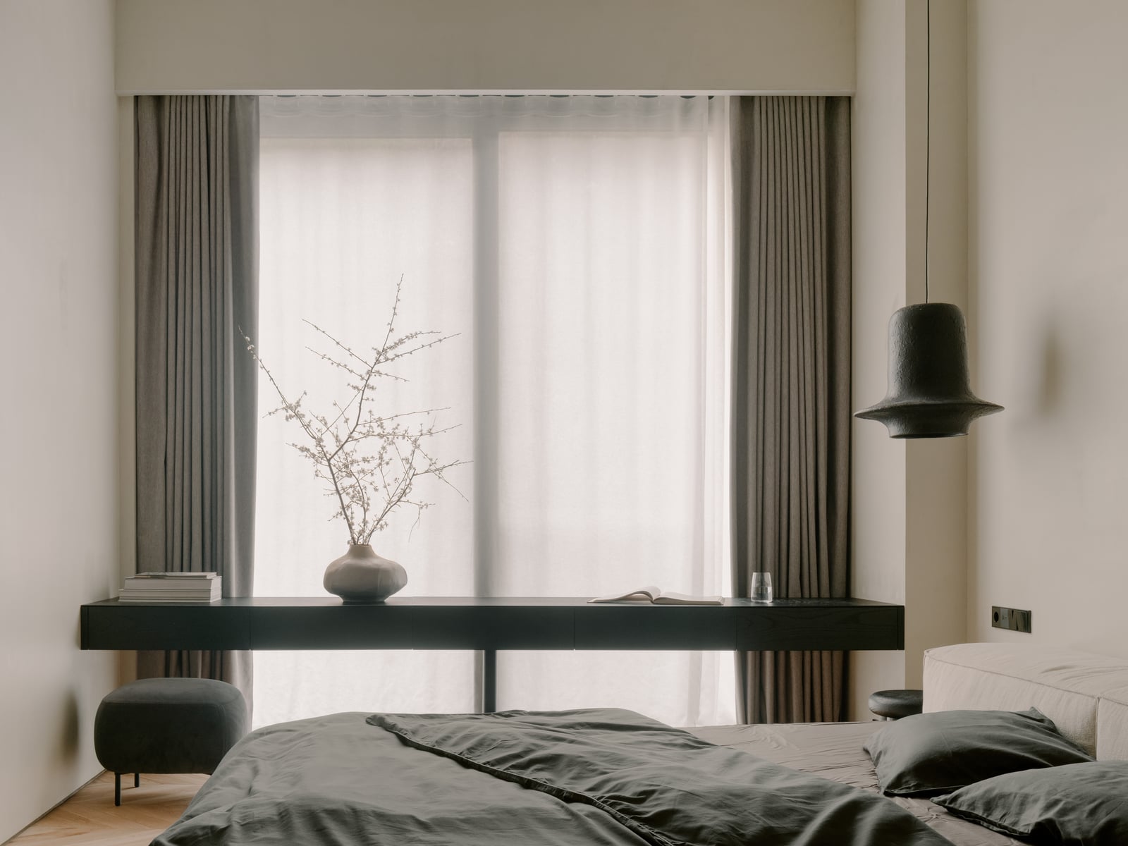 Bedroom with a bed, a black ledge shelf and a curtained window