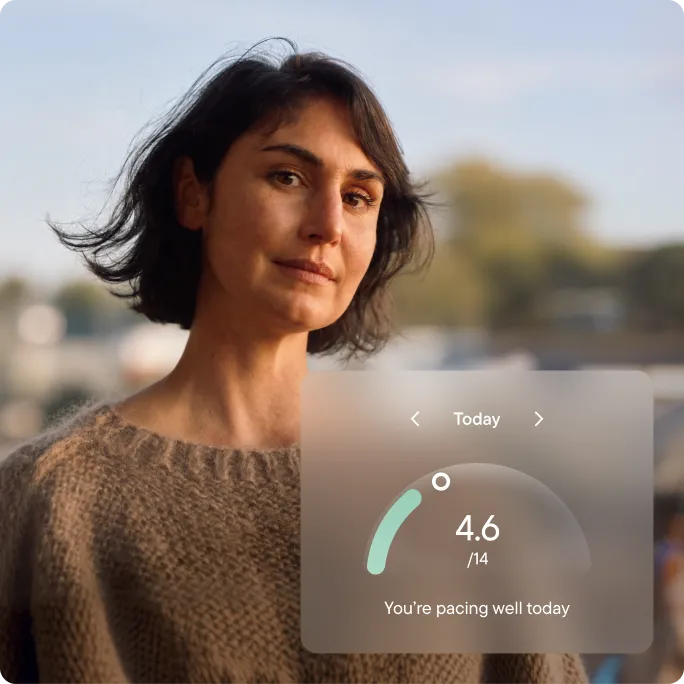 A woman with short dark hair outdoors in evening light. A Visible app overlay shows 4.6 out of 14 PacePoints used today, with the message ‘You’re pacing well today'