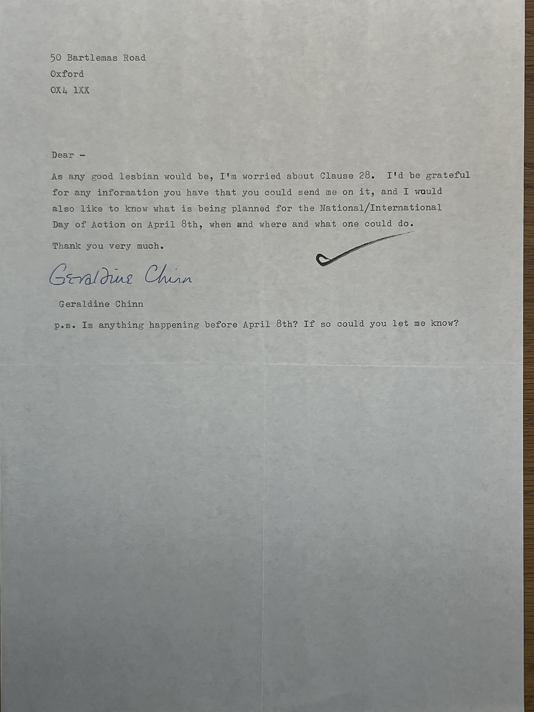 Typed letter on white paper with address 50 Bartlemas Road, Oxford OX4 1XX at top left. The letter expresses concern about Clause 28 and requests information about it, as well as plans for the National/International Day of Action on April 8th. Signed in blue ink by Geraldine Chinn with a handwritten flourish. A postscript asks if anything is happening before April 8th and requests to be informed.