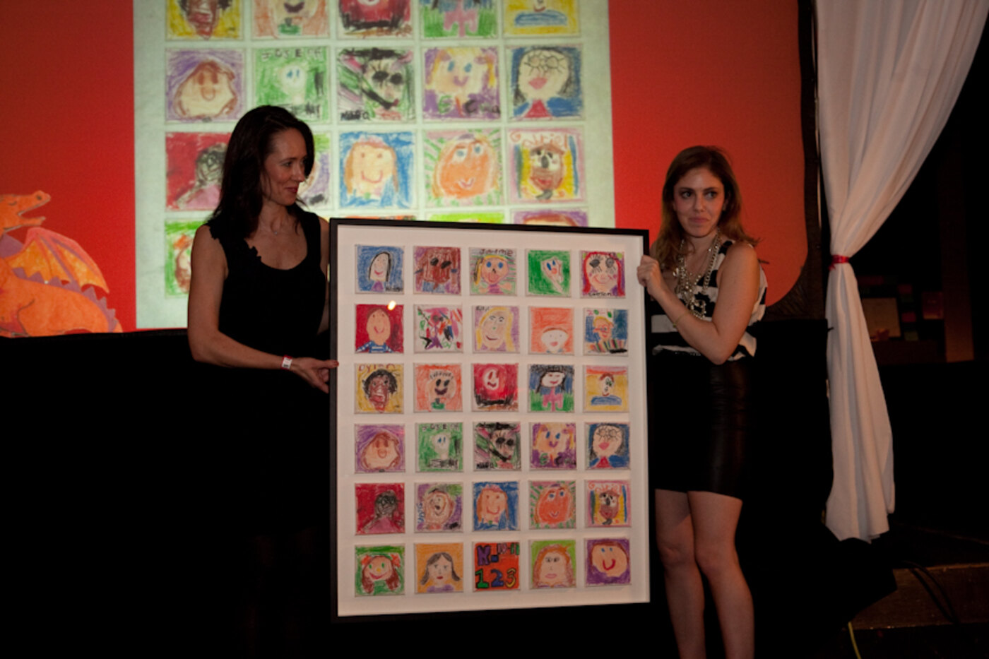 A framed class art piece presented on stage at the Anderson gala