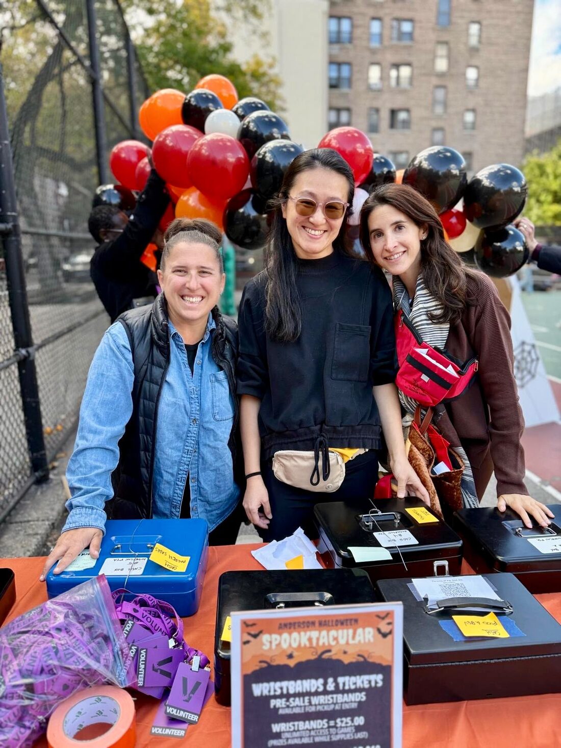 Parent volunteers at the Spooktacular wristbands and tickets table