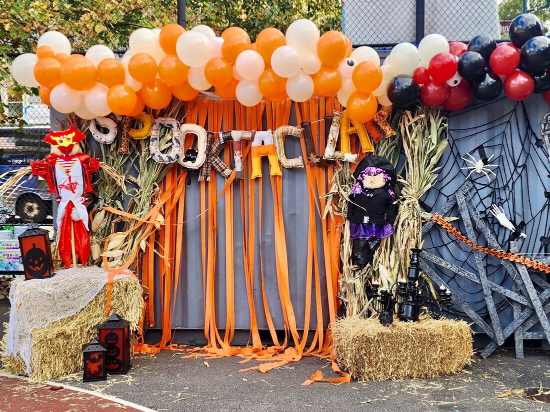 The Spooktacular entrance, decorated with balloons, cornstalks, a scarecrow and a witch