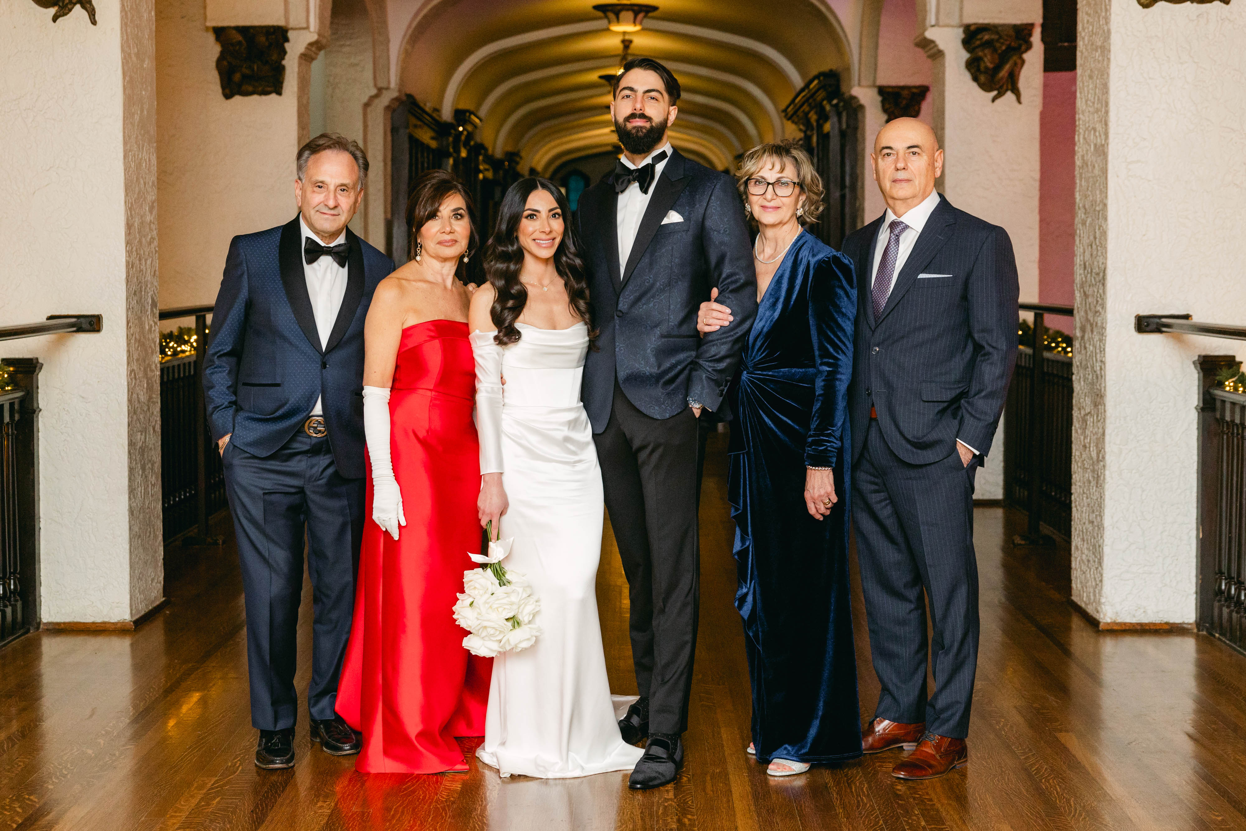 Wedding couple with family in formal attire