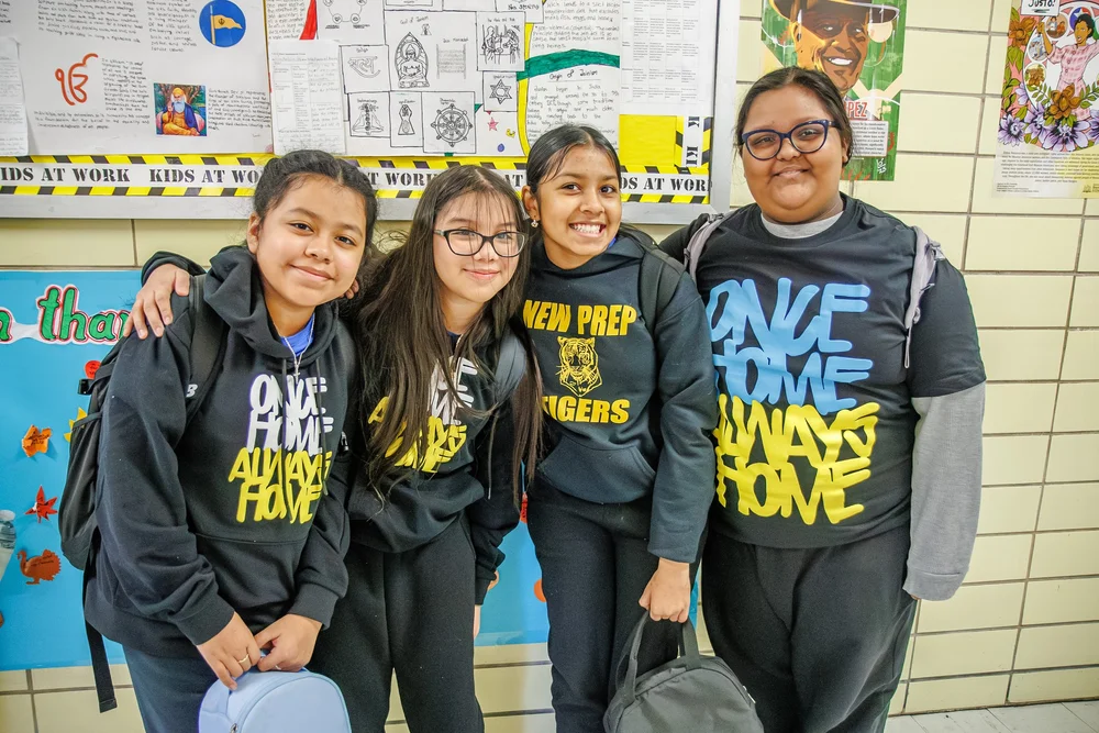 Four New Prep Tigers middle school students smiling in hallway