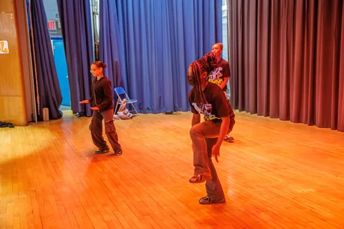 Two students practicing hip hop dance moves on school stage