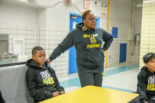 New Prep Tigers staff member with students in school cafeteria