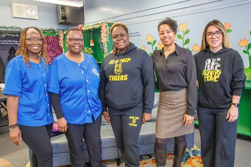 Five New Prep staff members smiling together indoors
