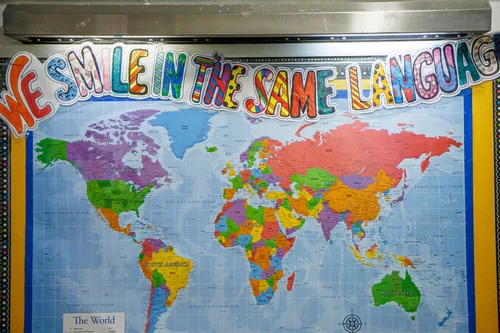 Classroom world map bulletin board reading We Smile in the Same Language
