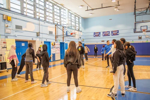 Students participating in a physical education class in school gymnasium