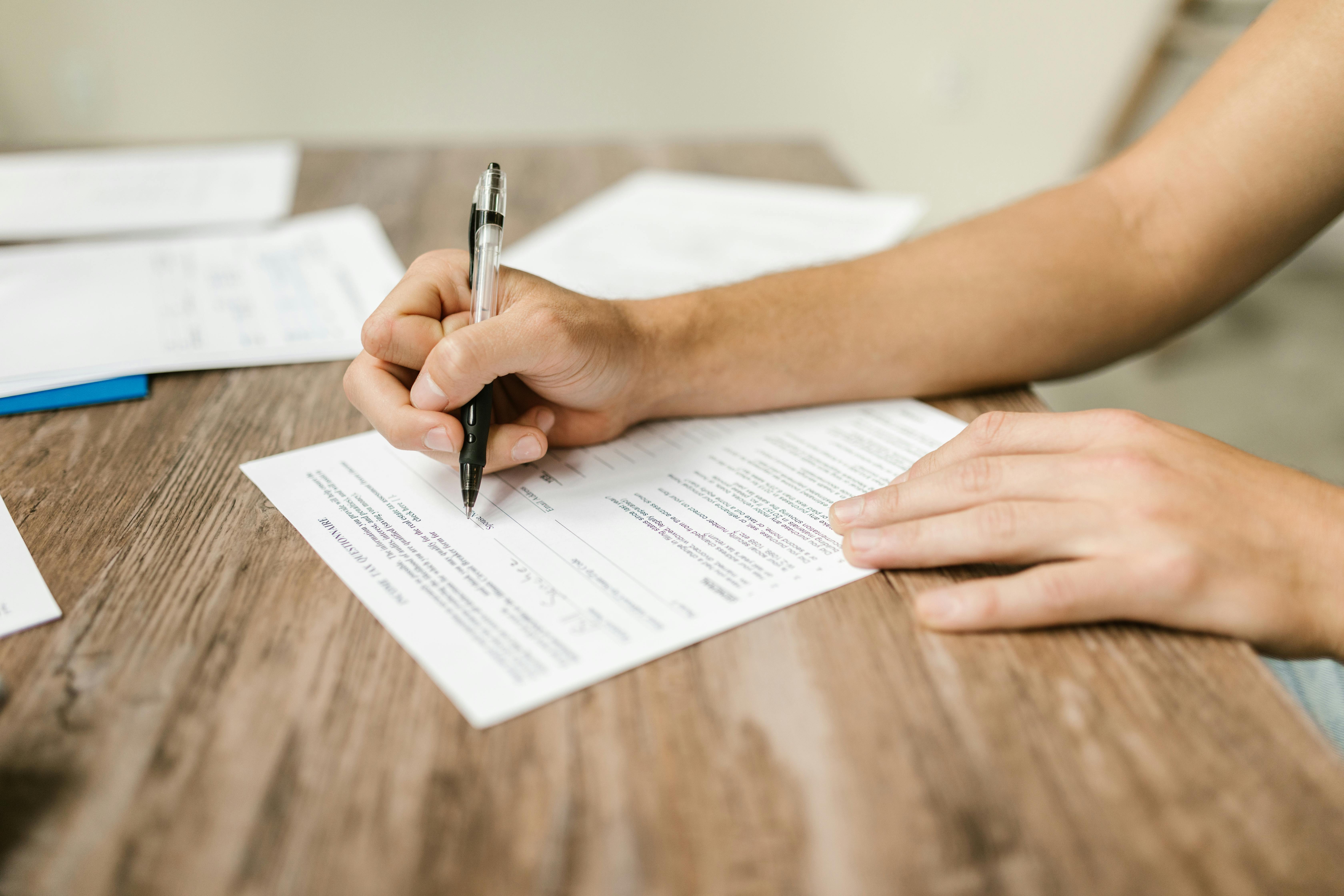 man filling a form - How to Dissolve a Corporation in Delaware