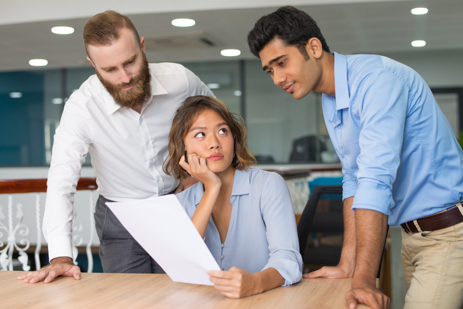 employees looking at a document - How To Dissolve An LLC In Alabama 