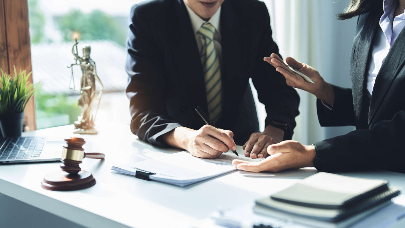 person with her lawyer - How To Dissolve An LLC In Texas
