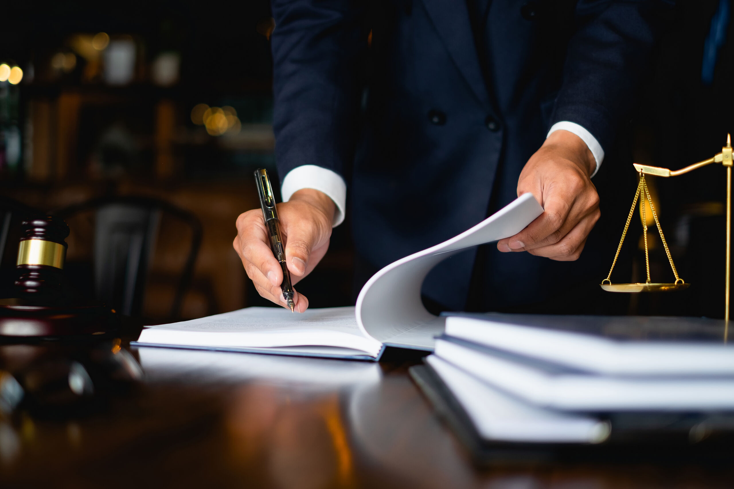 man signing a document - How to Dissolve an LLC in Maine