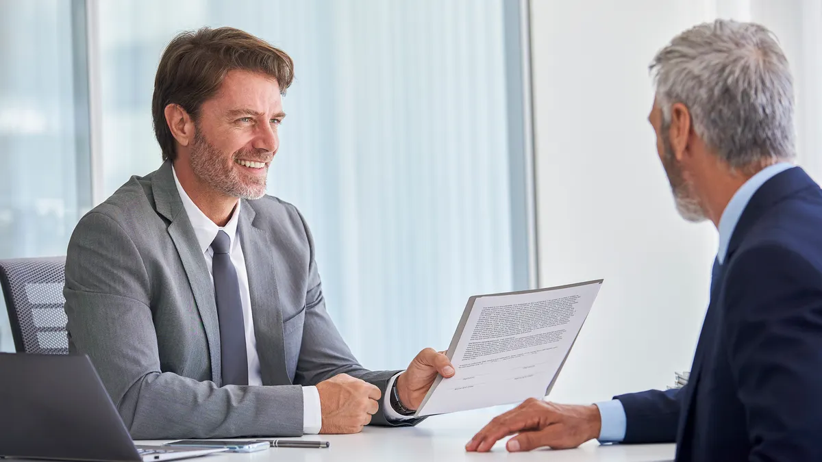 man with documents - How to Dissolve an LLC in Maine