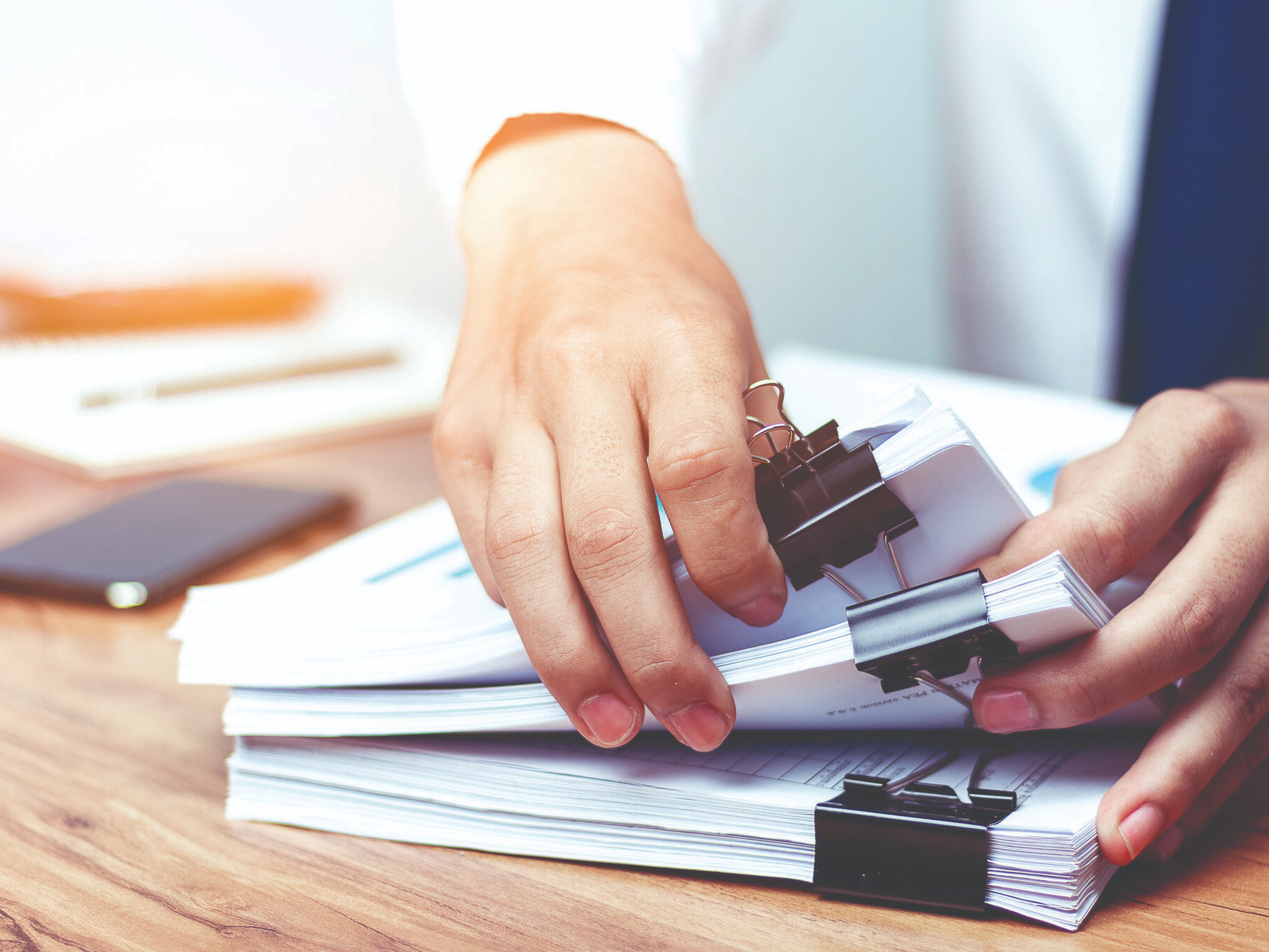 person sorting documents - How to Dissolve an LLC in Maine