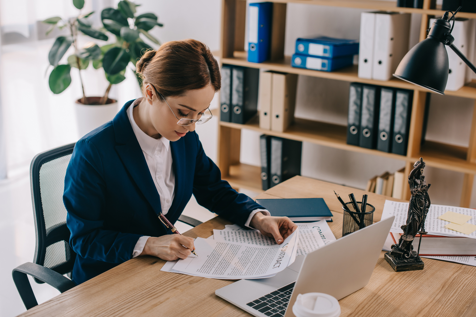 person reading contract - How to Dissolve an LLC in Michigan