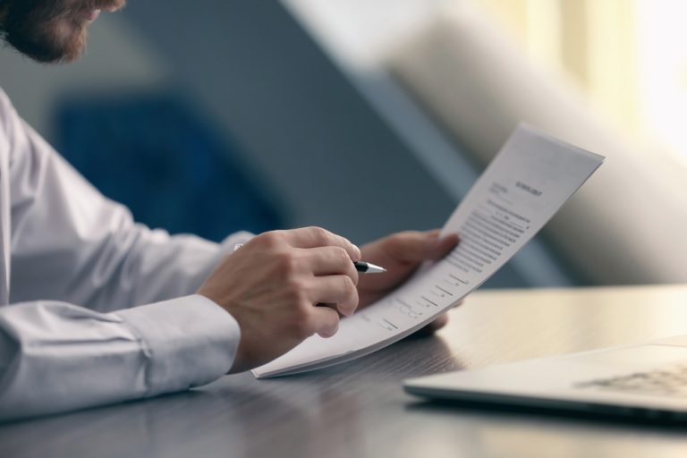 man reading a documents - How To Dissolve An LLC In Maryland