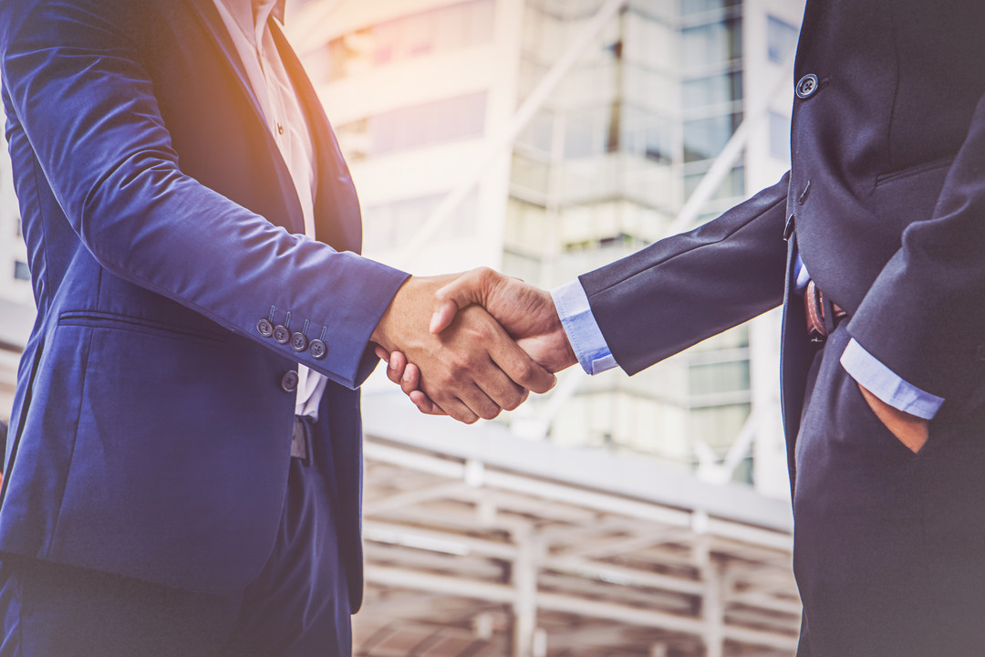 employees shaking hands - How To Dissolve An LLC In Maryland