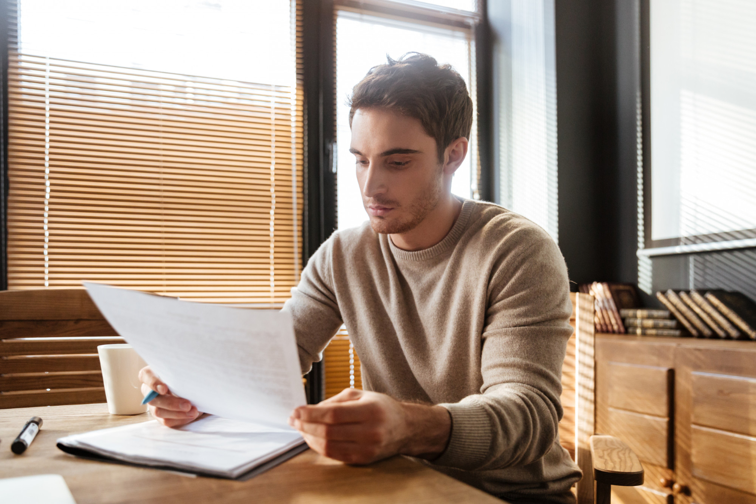 person wearing a brown sweater - How To Dissolve an LLC in New Mexico