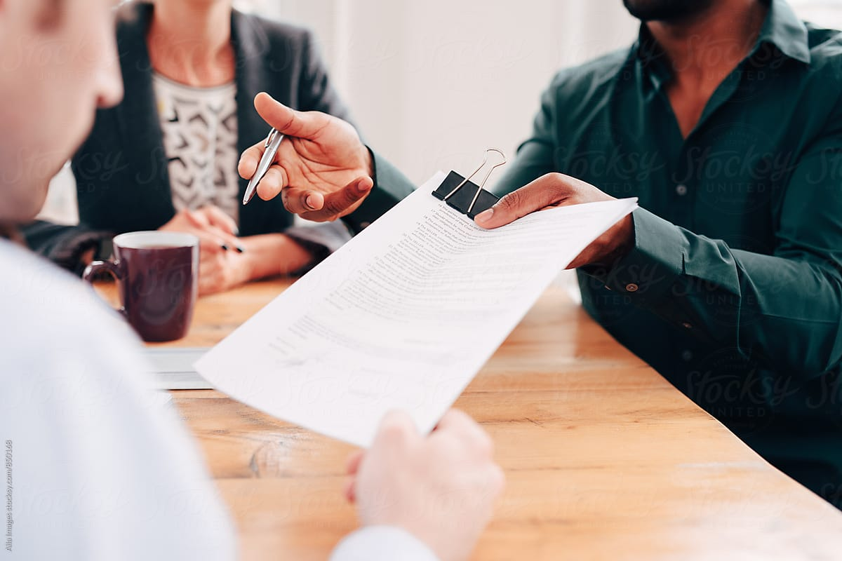 person handing over documents - How To Dissolve An LLC In Oklahoma