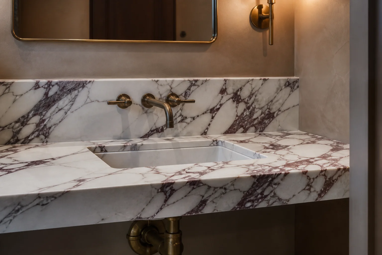 Violet-veined marble vanity and backsplash with a brass wall faucet