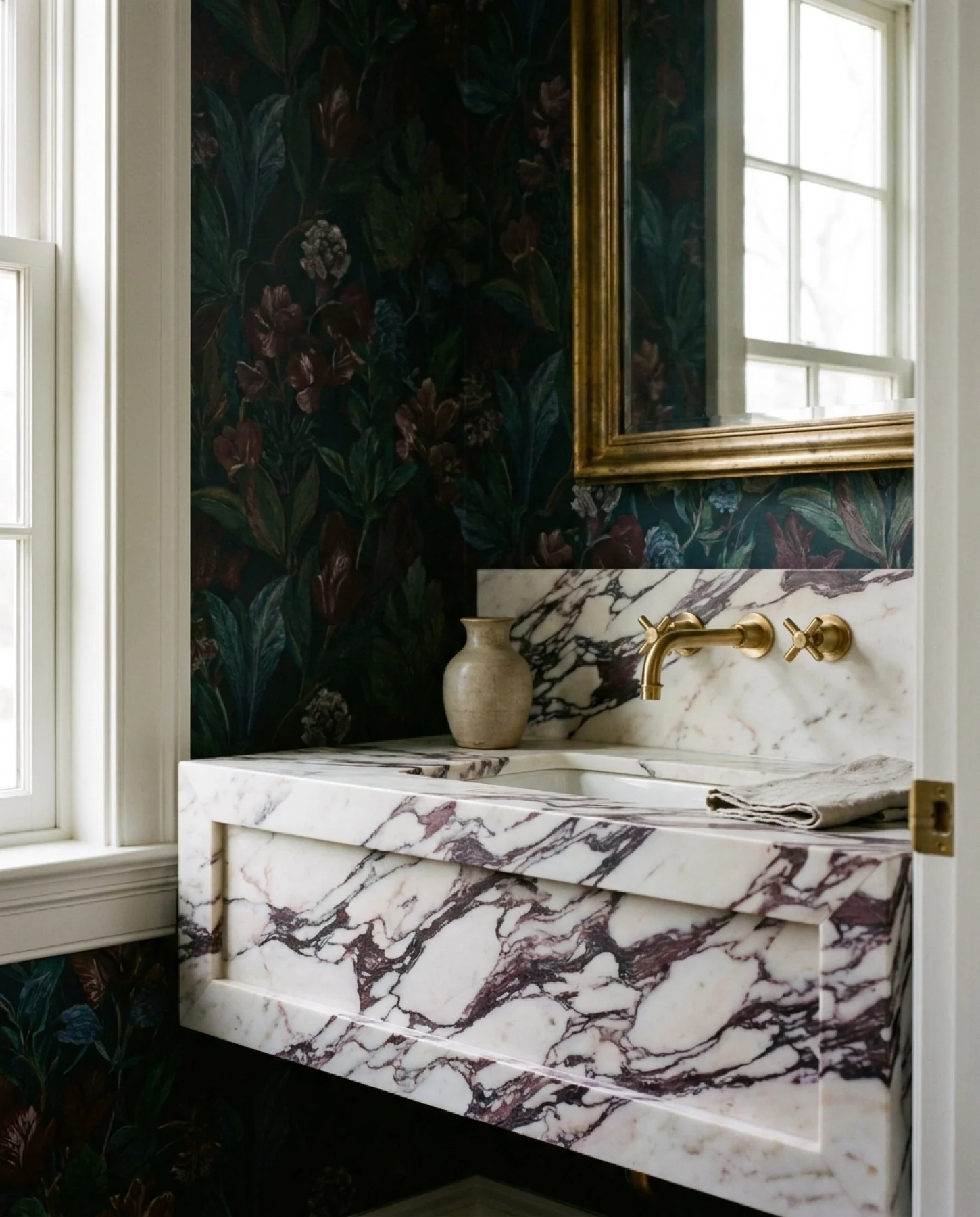 Original portrait view of the floating Calacatta Viola vanity and bold plum veining.
