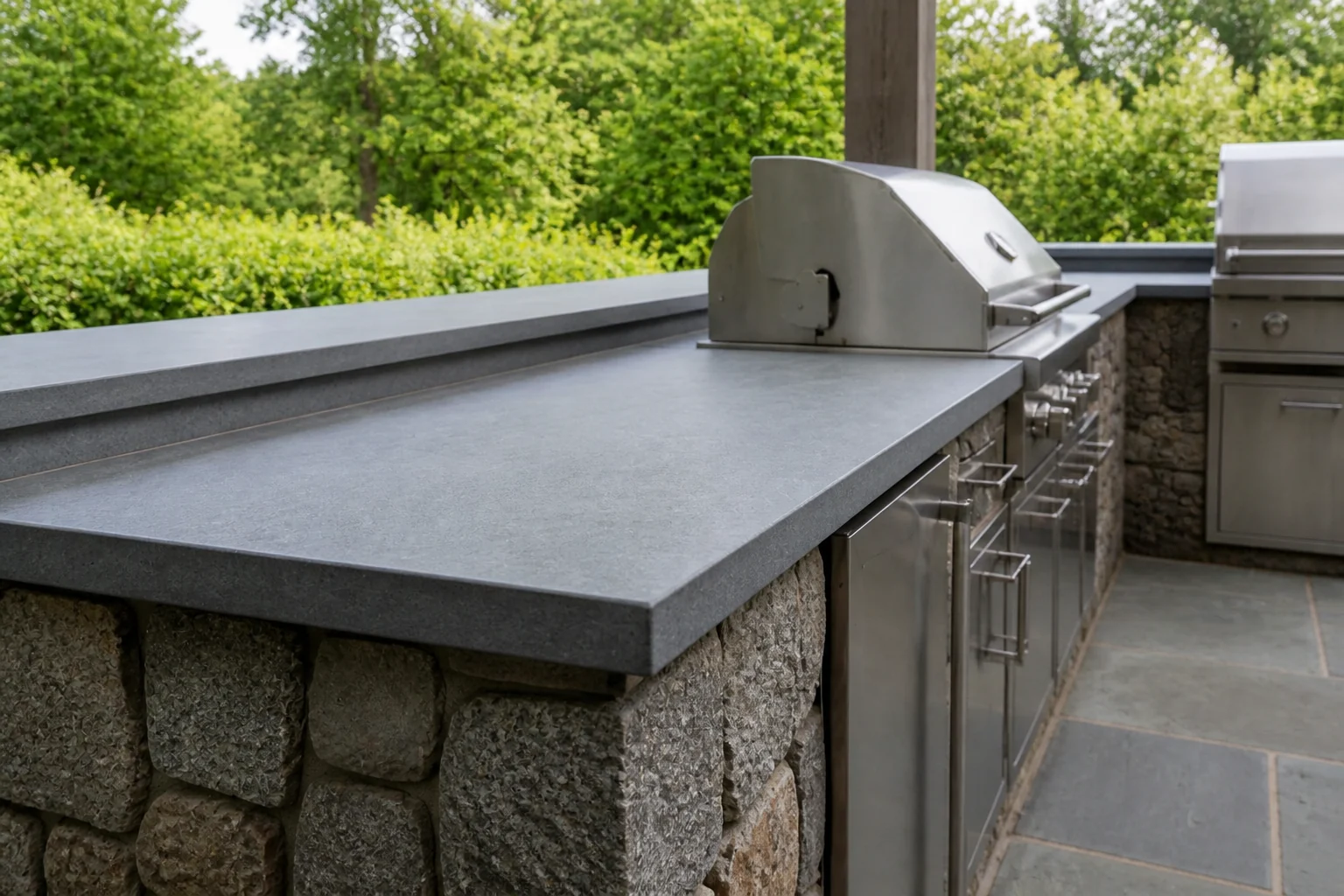 Gray porcelain bar overhang and built-up edge above the stone-clad base.