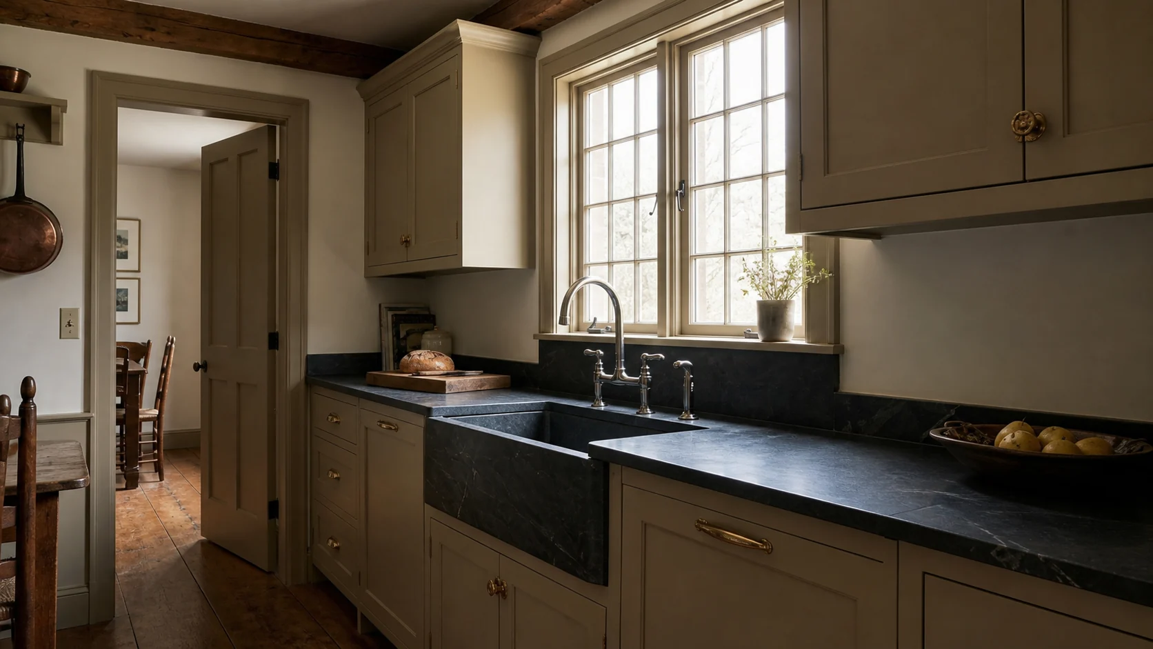 Soapstone perimeter counter, matching window sill, and integral sink in the farmhouse kitchen.