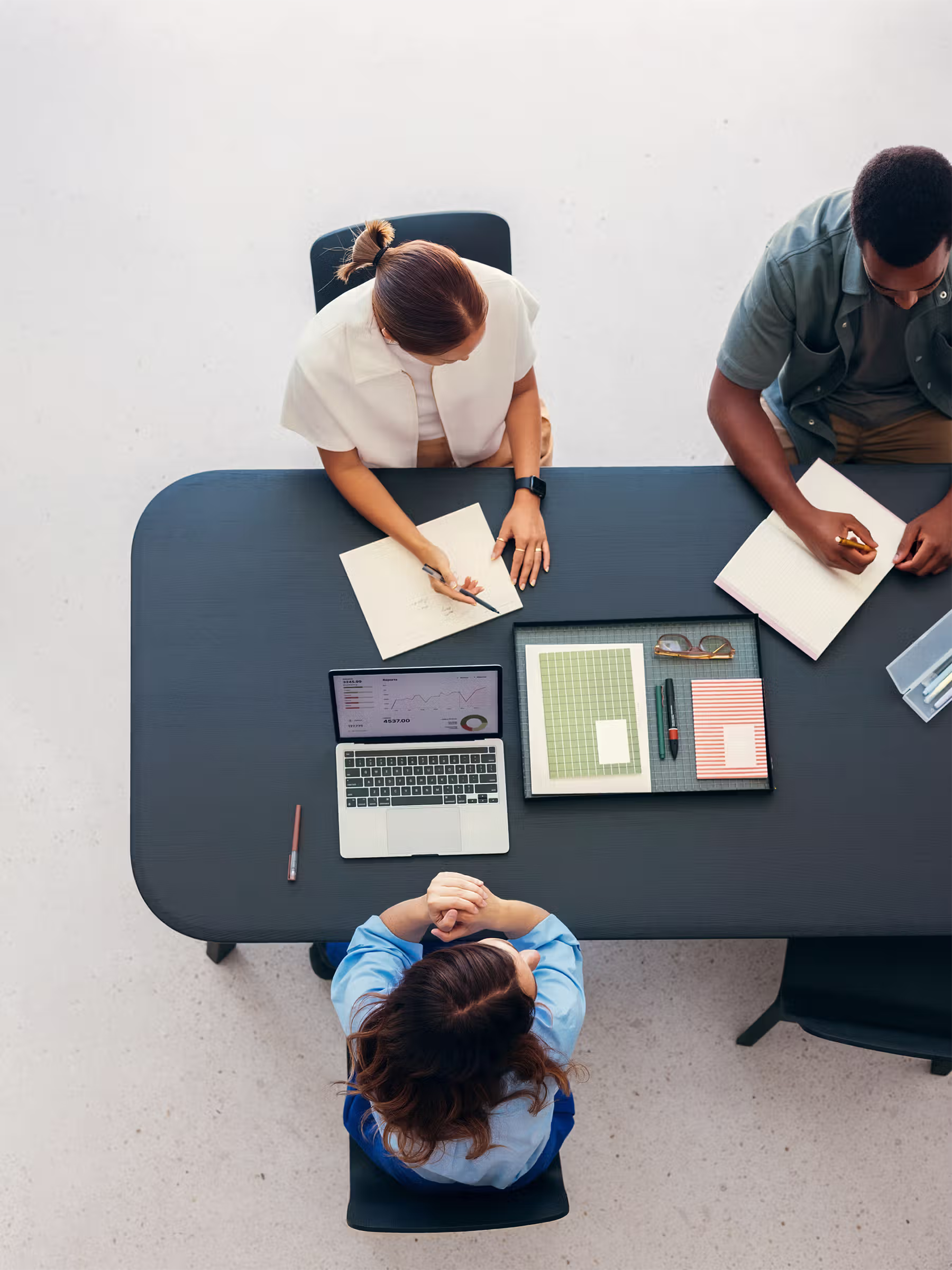 Professionals working together on a computer during a focused team discussion.