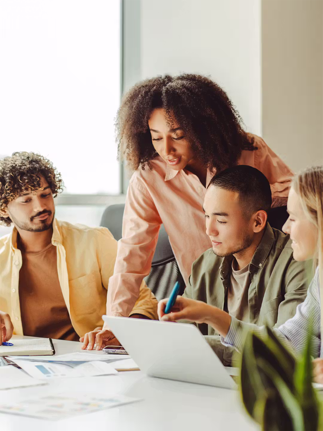 Business professionals reviewing content together on a shared screen in an office.