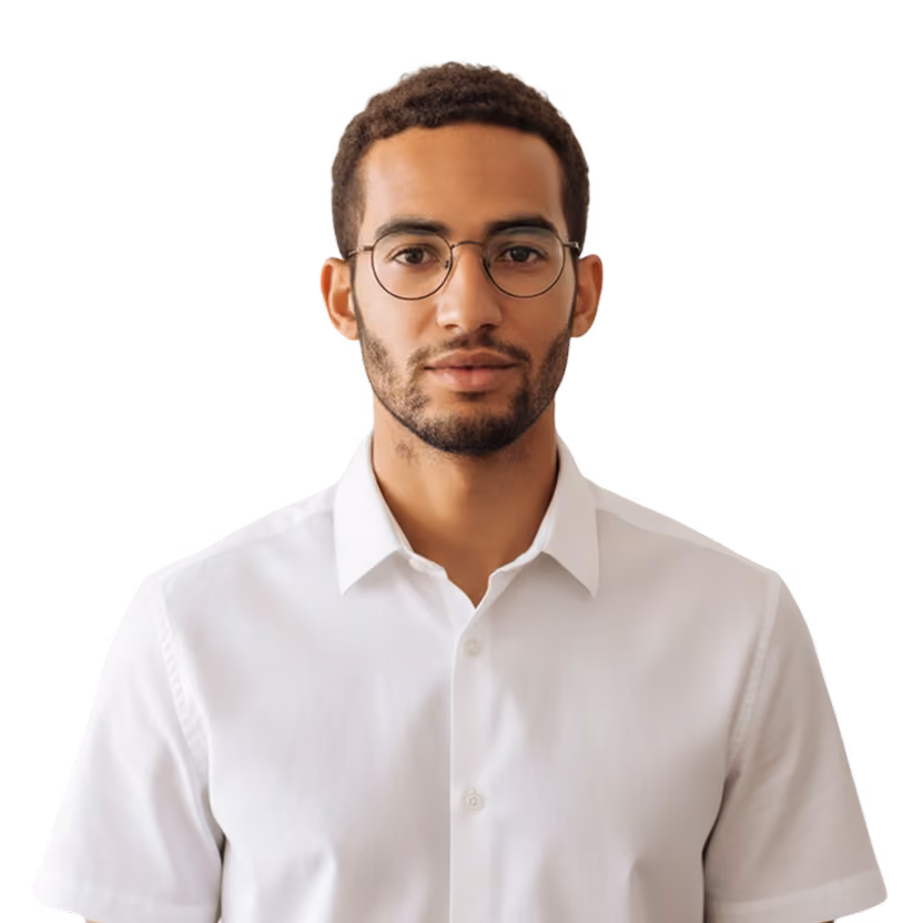 Young man with short curly hair, glasses, and a white shirt looking straight ahead.