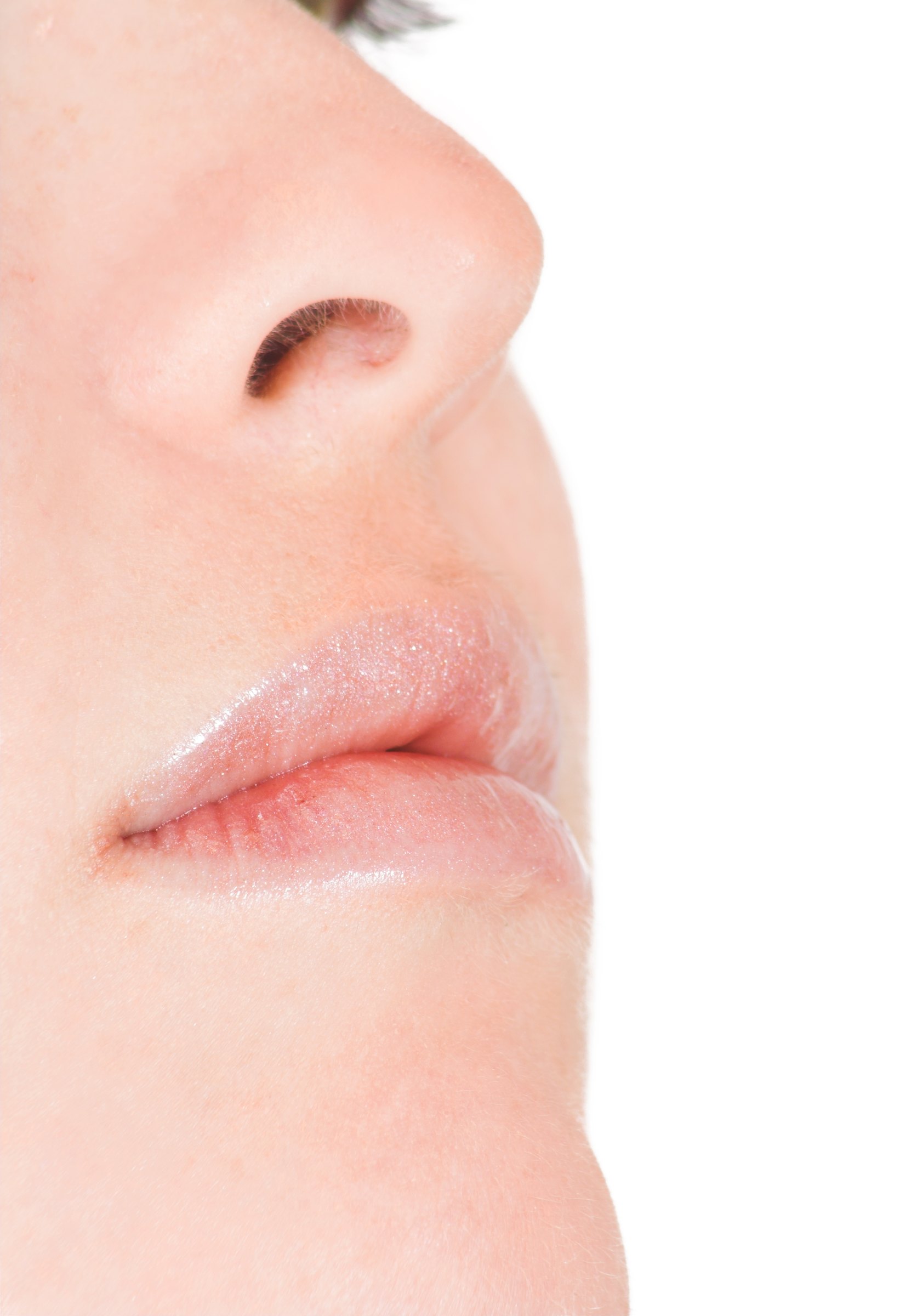 Clean profile close-up of a nose, mouth and chin against white