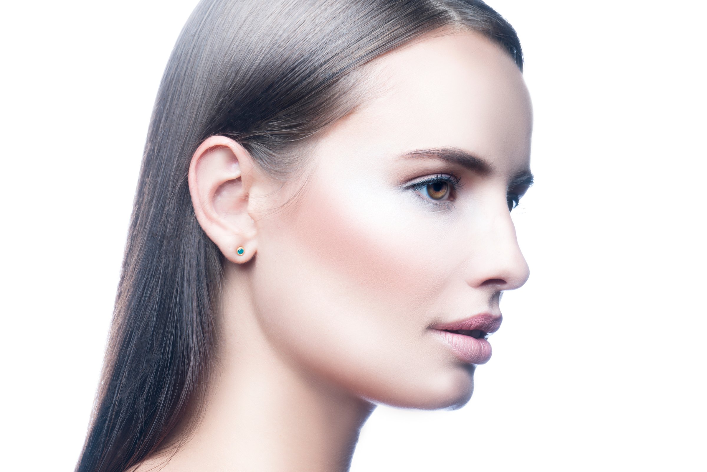 Clean profile portrait showing the line of the jaw and neck, pale background