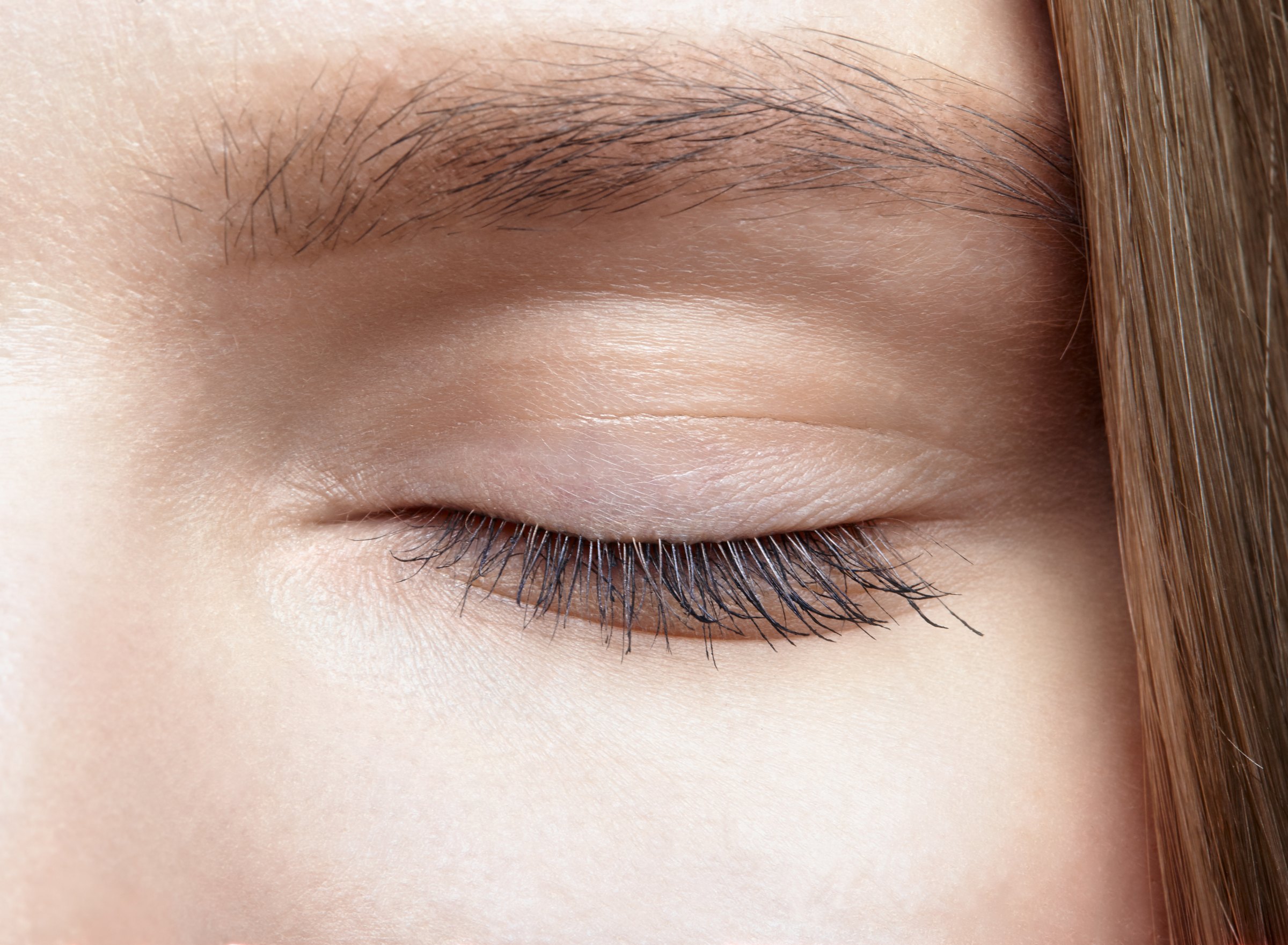 Close-up of a closed eye and lashes in soft, diffuse light