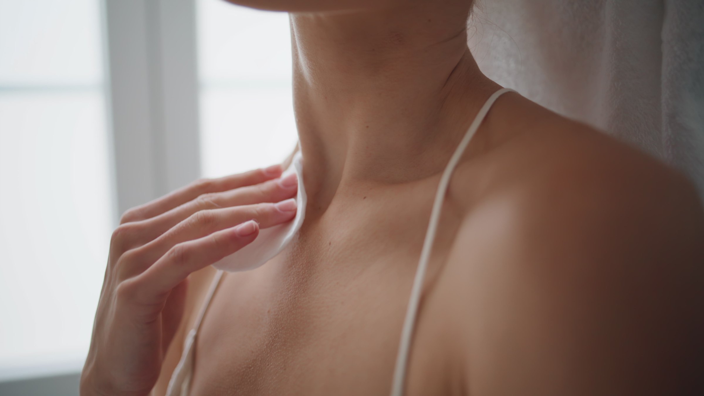 Soft close-up of a neck and collarbone in diffuse light