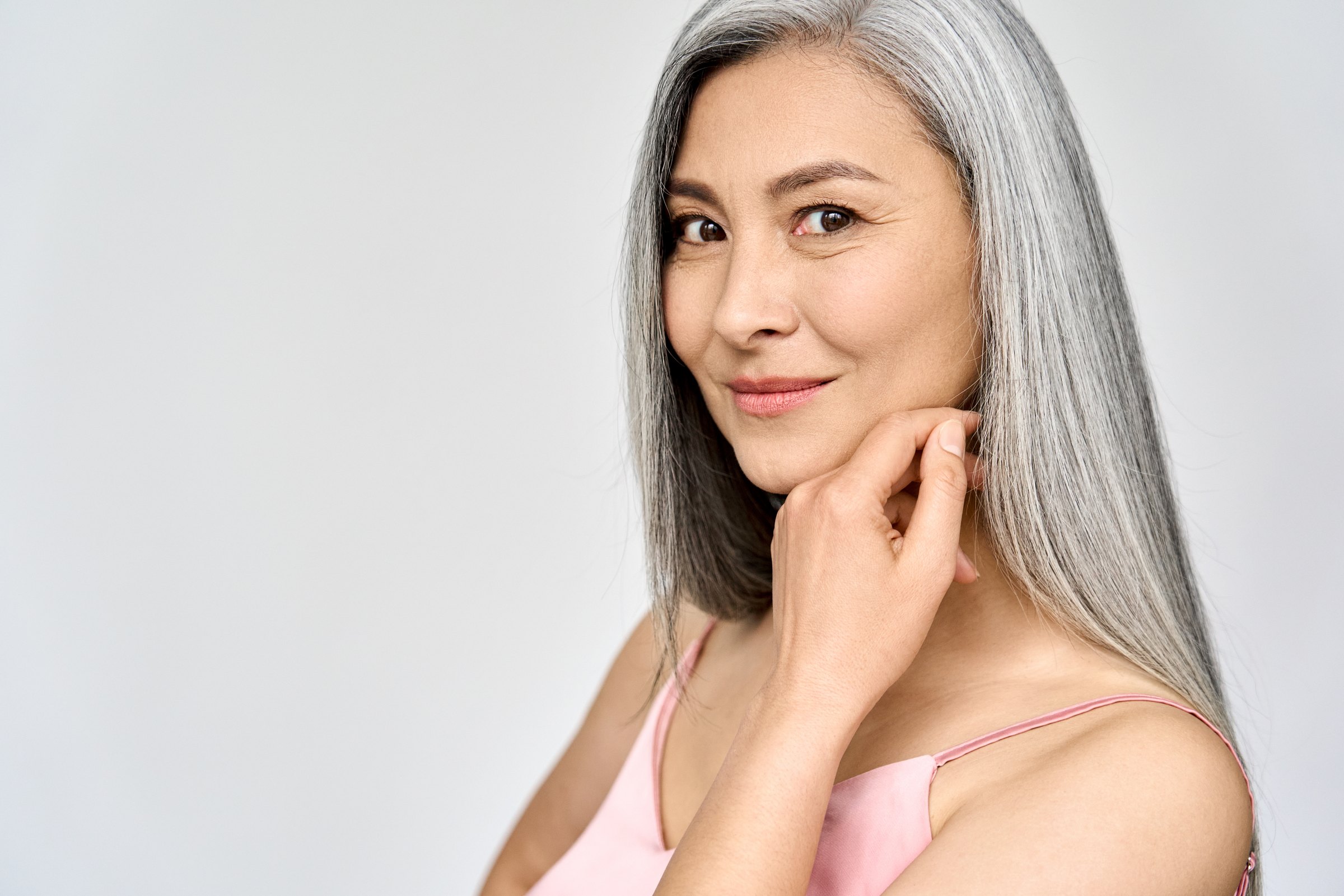 Portrait of a silver-haired woman, hand resting against her cheek