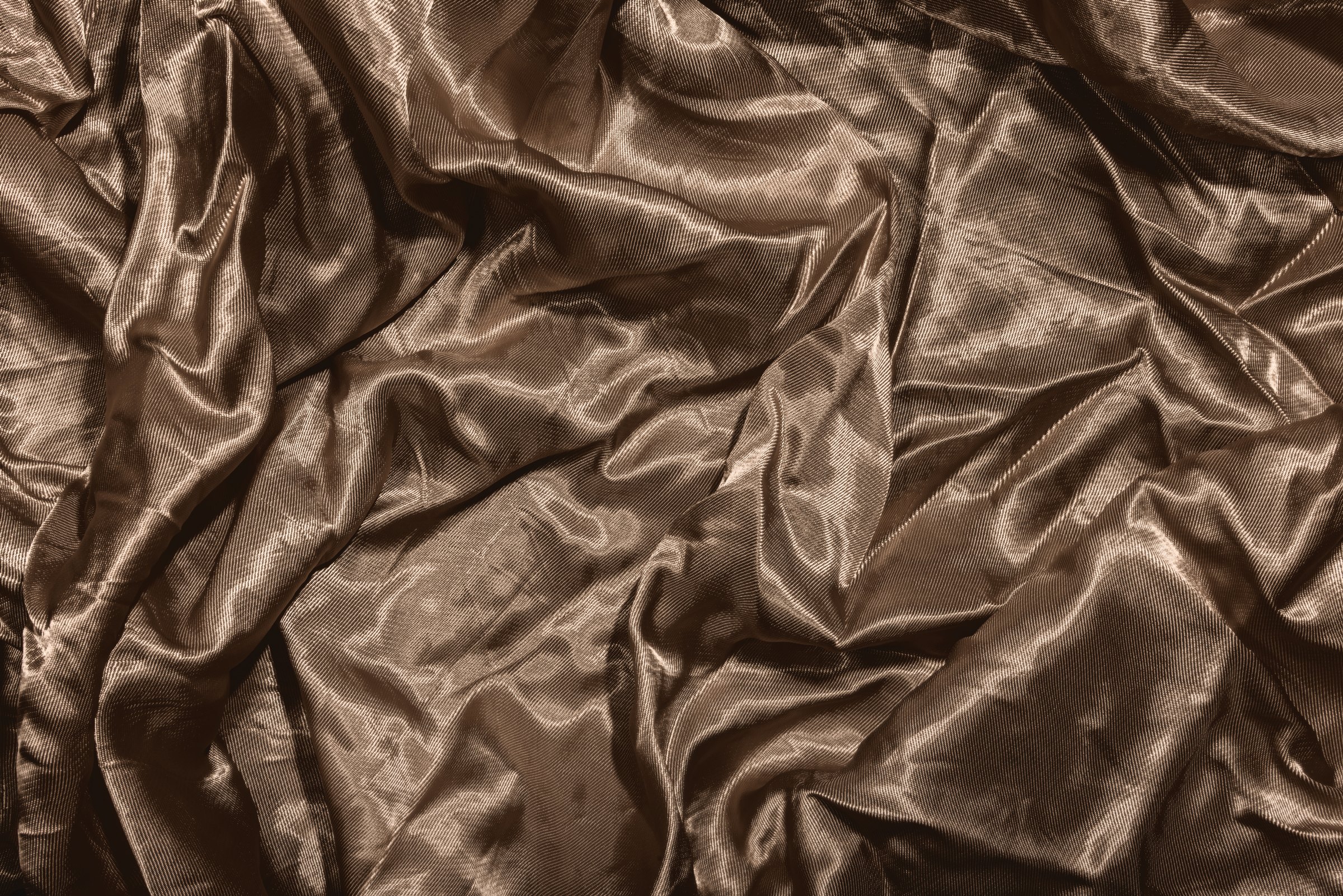 Bronze silk gathered into deep, warm folds