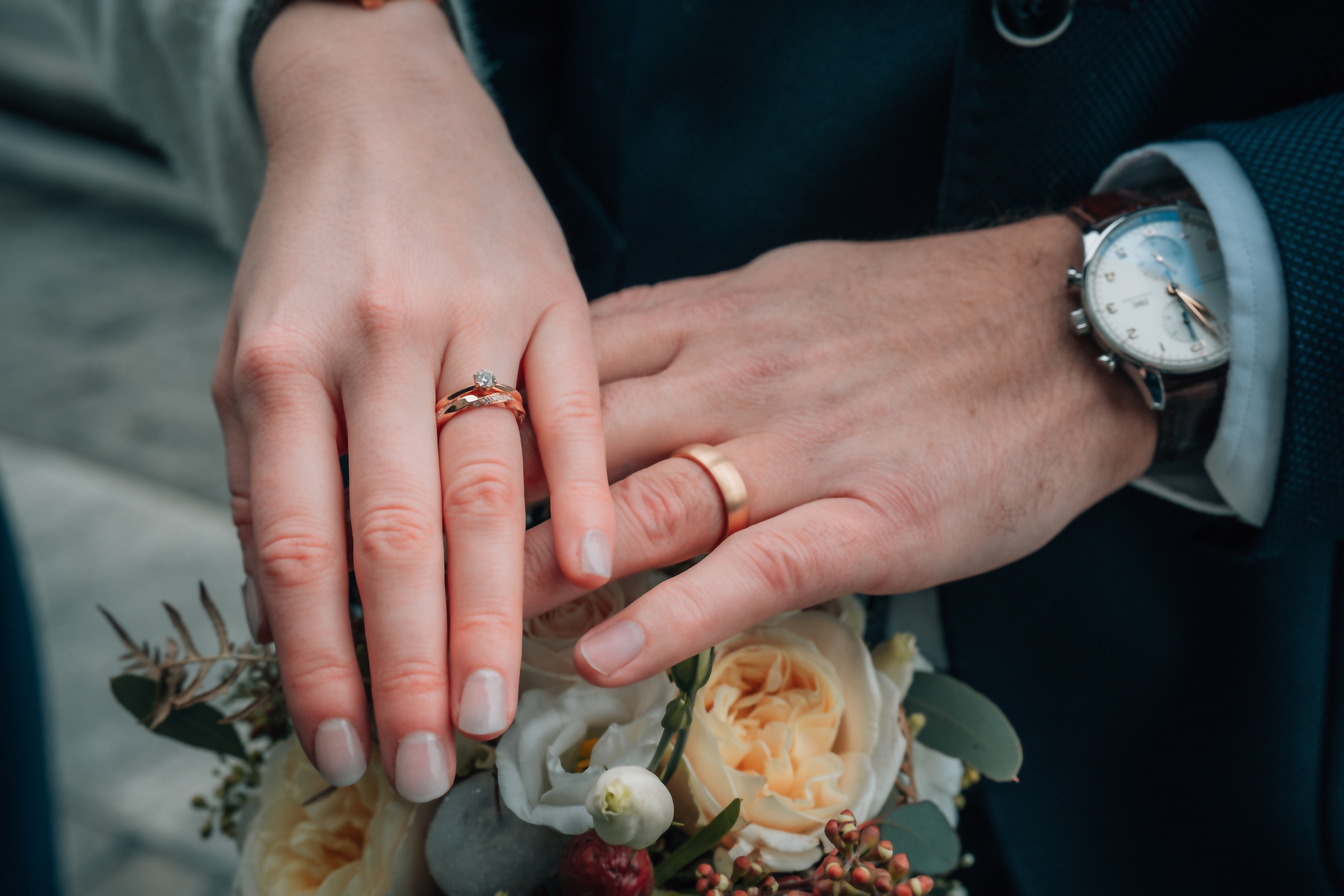 Wedding rings resting in a couple's hands at Borgo Filari