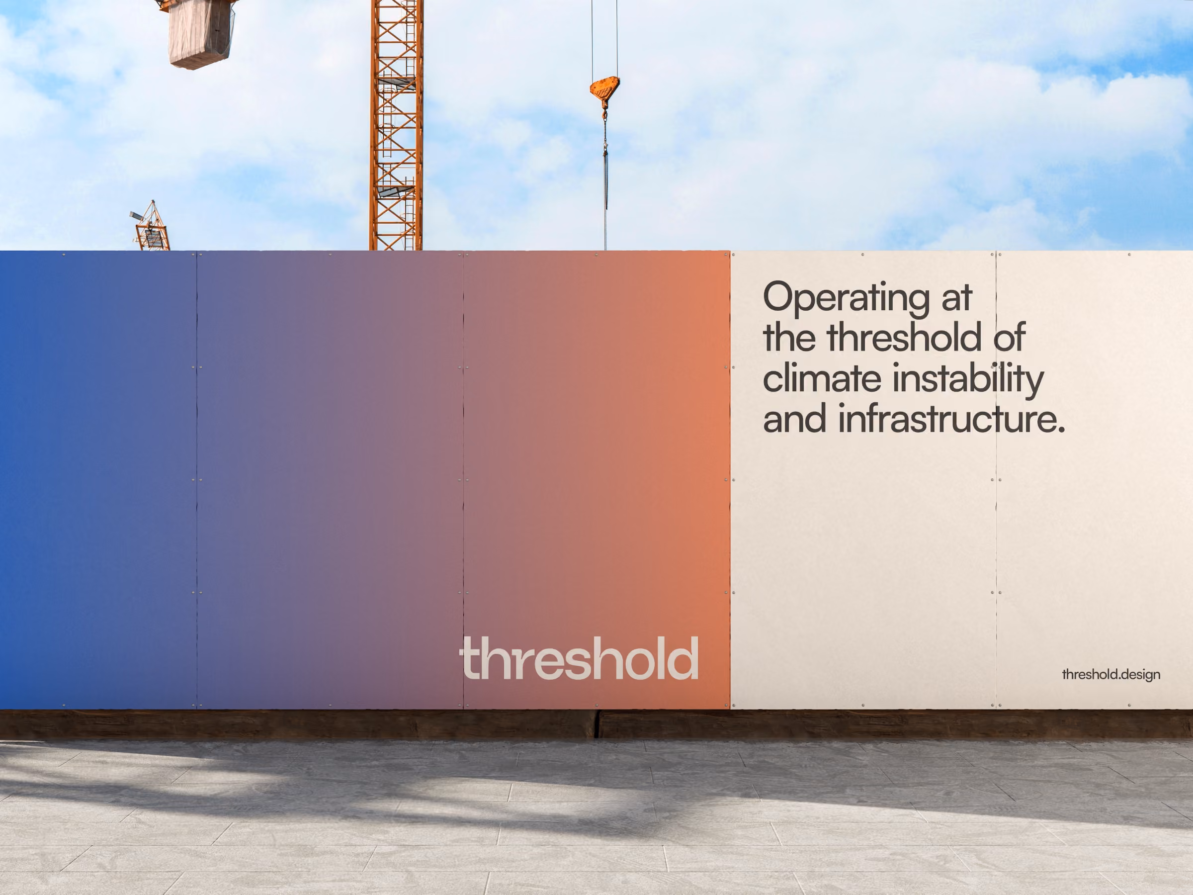Threshold Studio construction barrier with a gradient from blue to red and text reading 'Operating at the threshold of climate instability and infrastructure'.