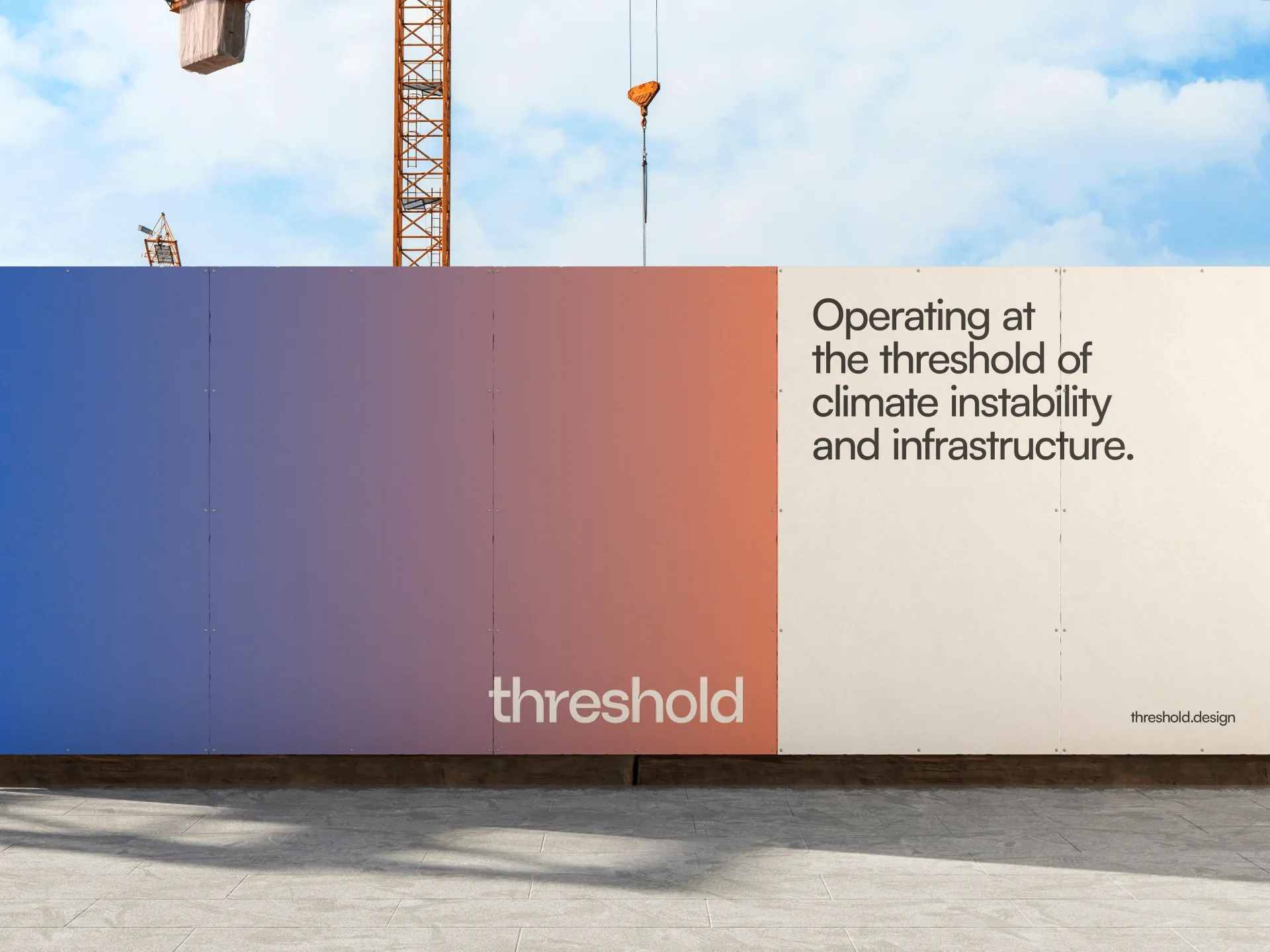 Construction barrier with a gradient from blue to red and text reading 'Operating at the threshold of climate instability and infrastructure' with 'threshold' logo and cranes in the background.