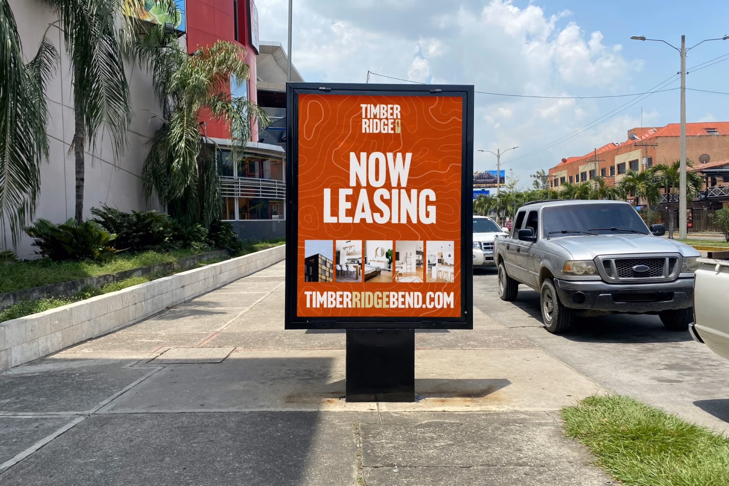 Outdoor display board on a sidewalk showing Timber Ridge leasing advertisement.