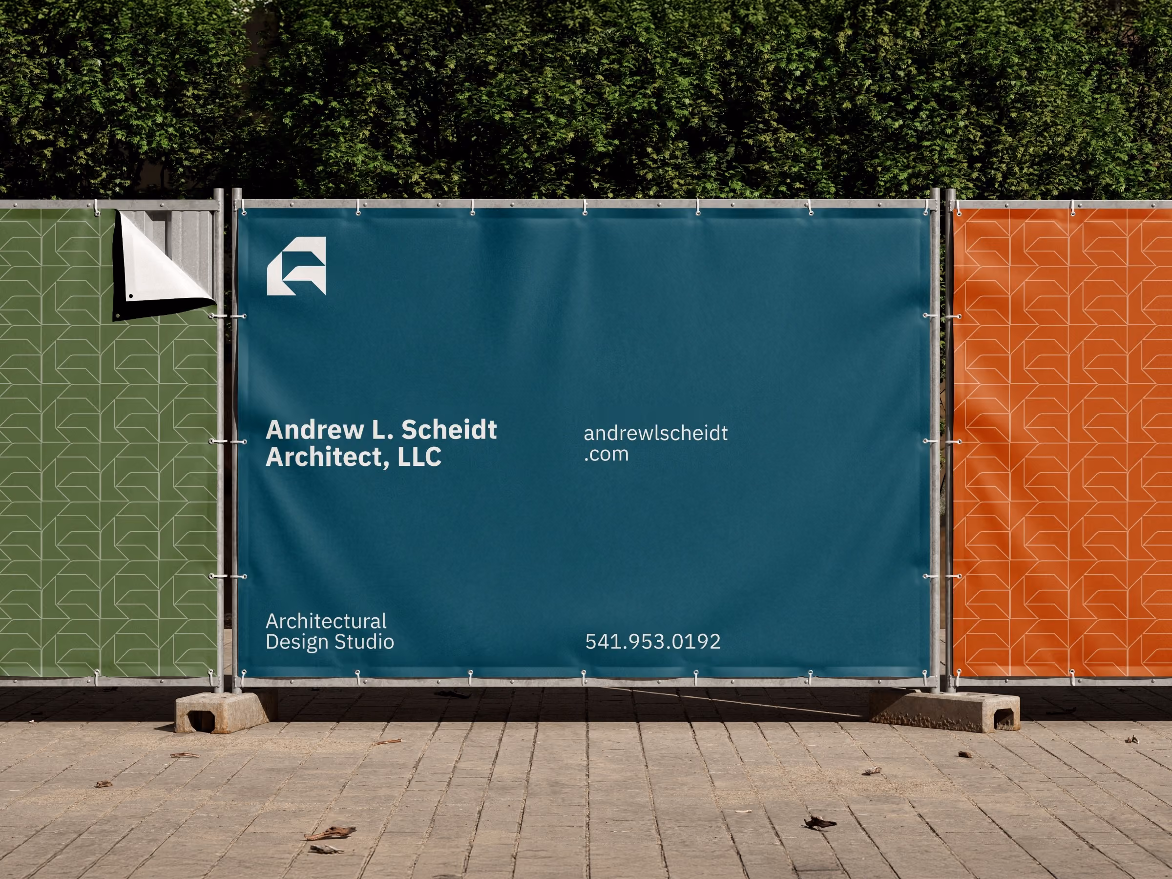 Construction site barrier with a teal banner displaying the text Andrew L. Scheidt Architect, LLC