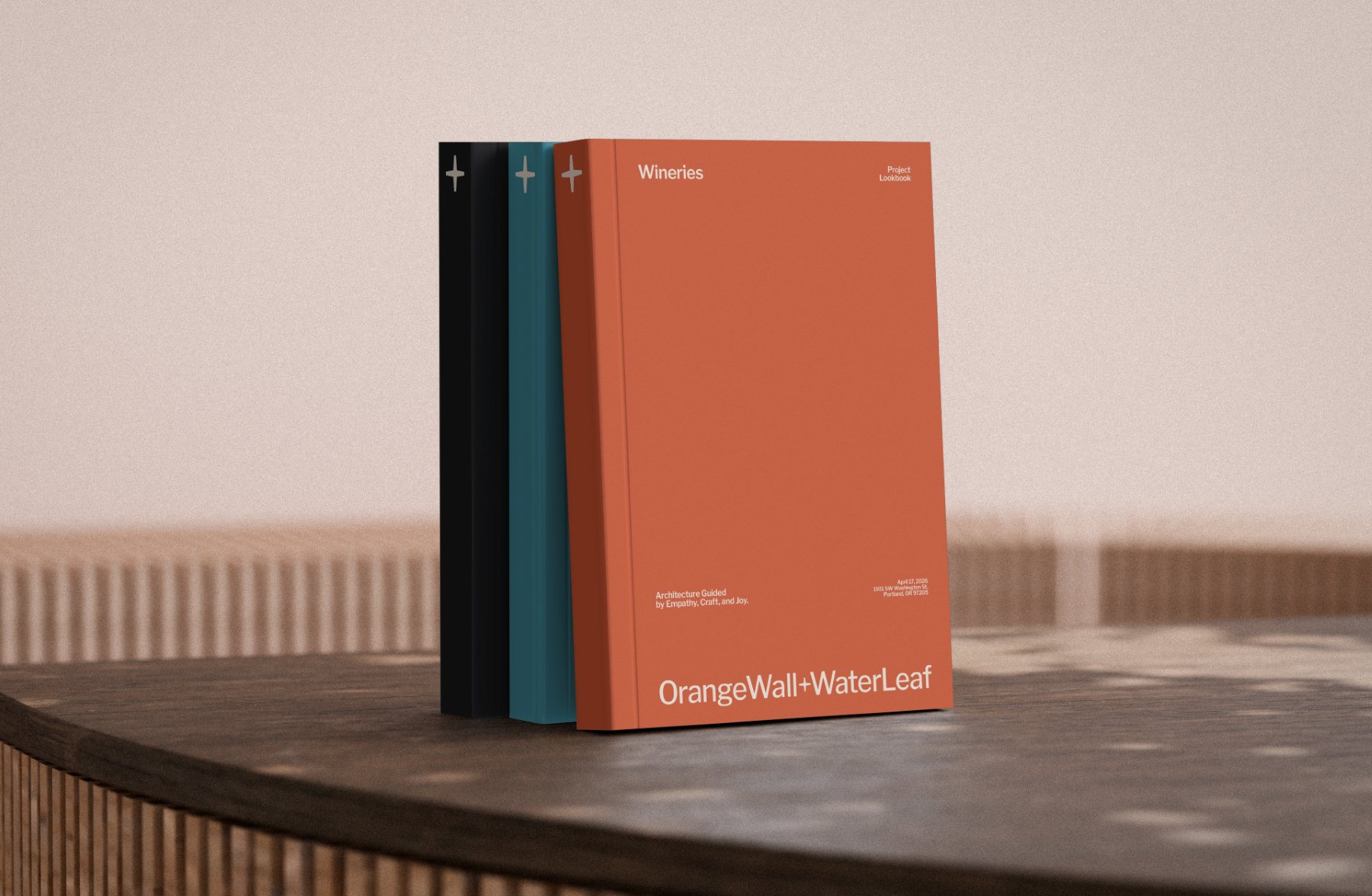 3 portfolio books stacked vertical together featuring OrangeWall+WaterLeaf branding.