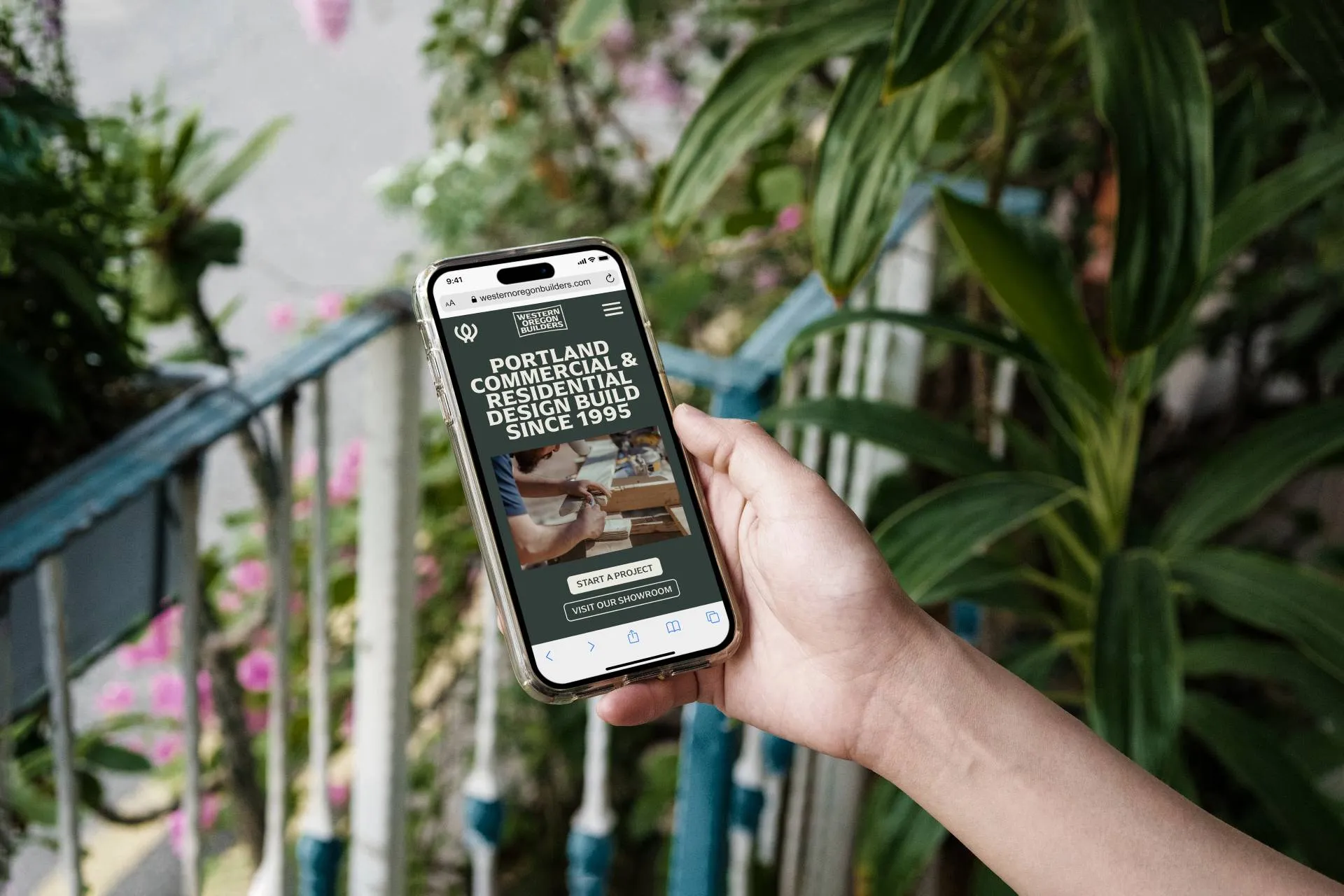 Person holding phone open to a website with green background.