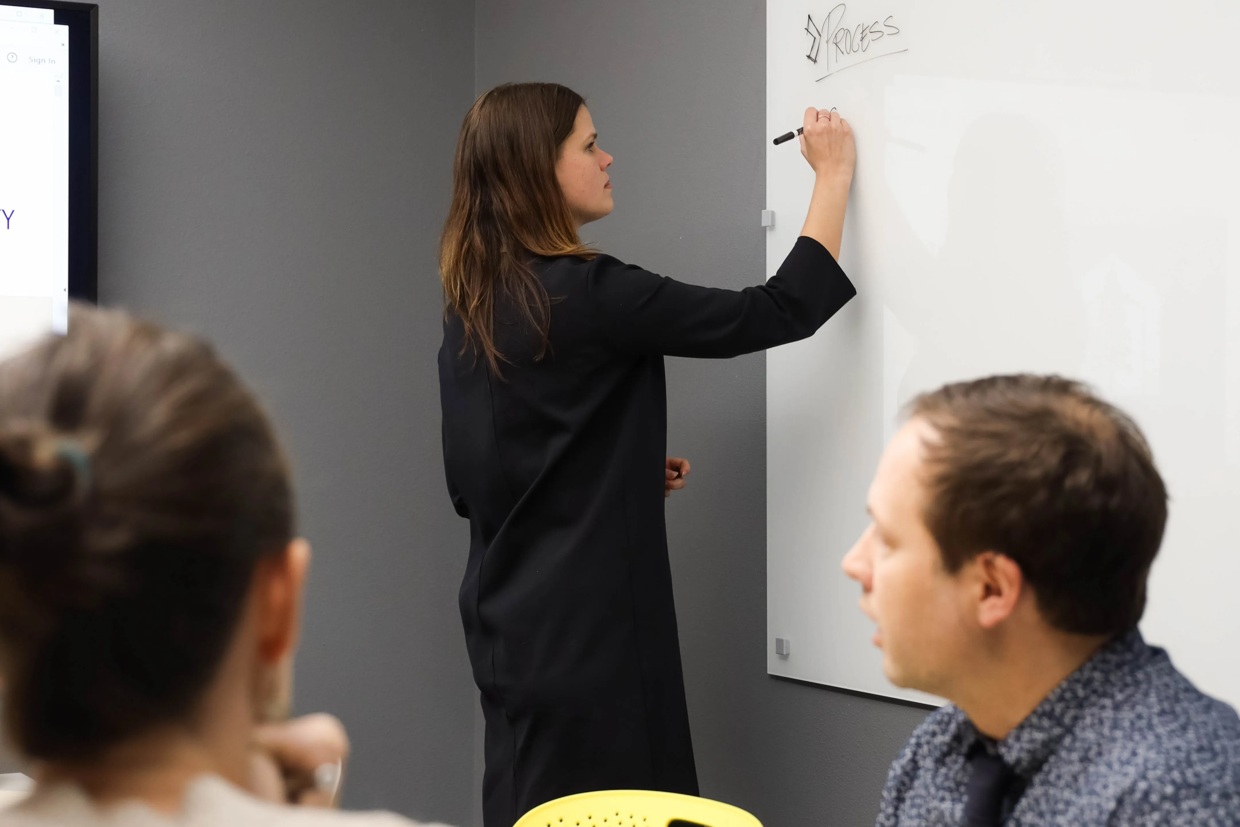 3 people in conference room planning a project.