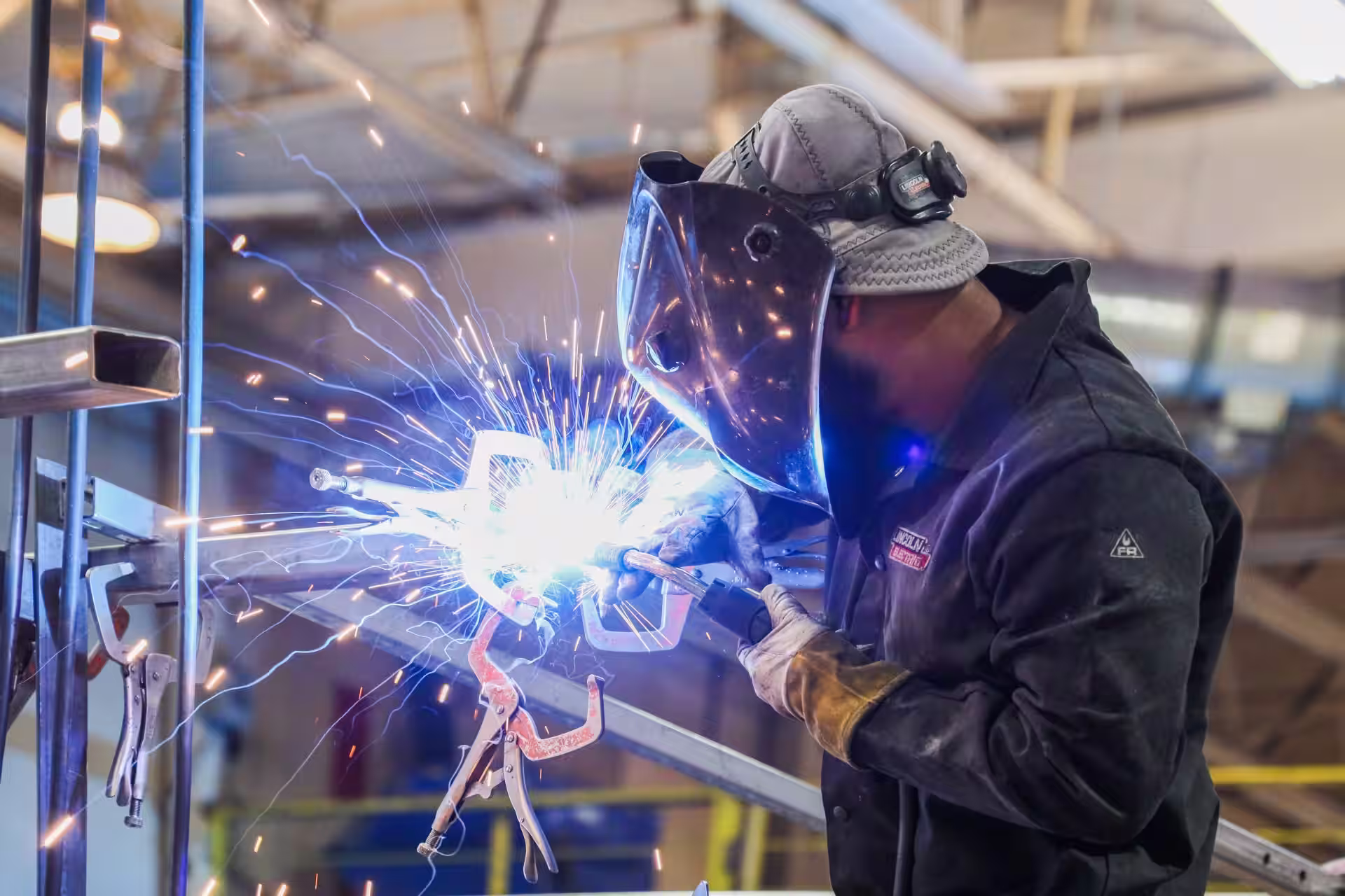 Sheet metal worker welding on a LU 49 job site