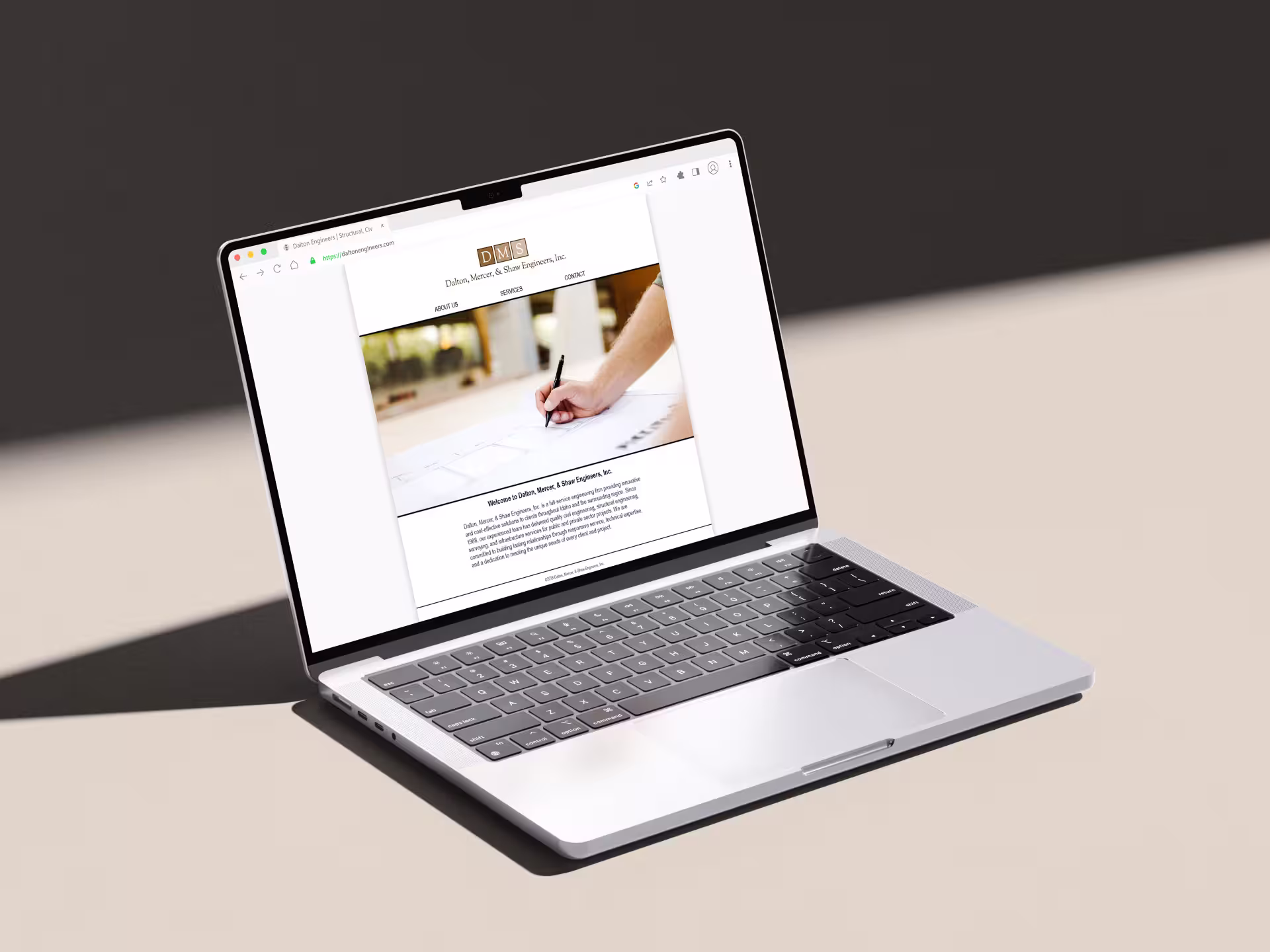 Old engineering firm website open to homepage on laptop