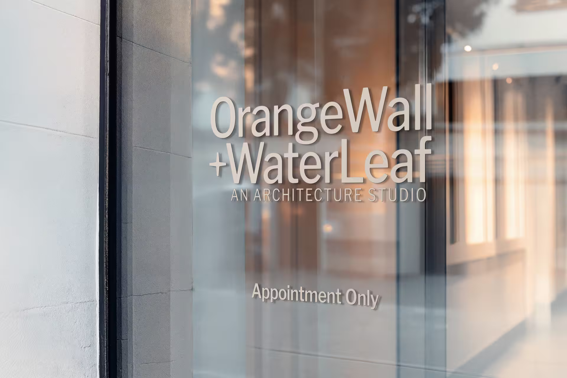 OrangeWall+WaterLeaf signage on glass door.