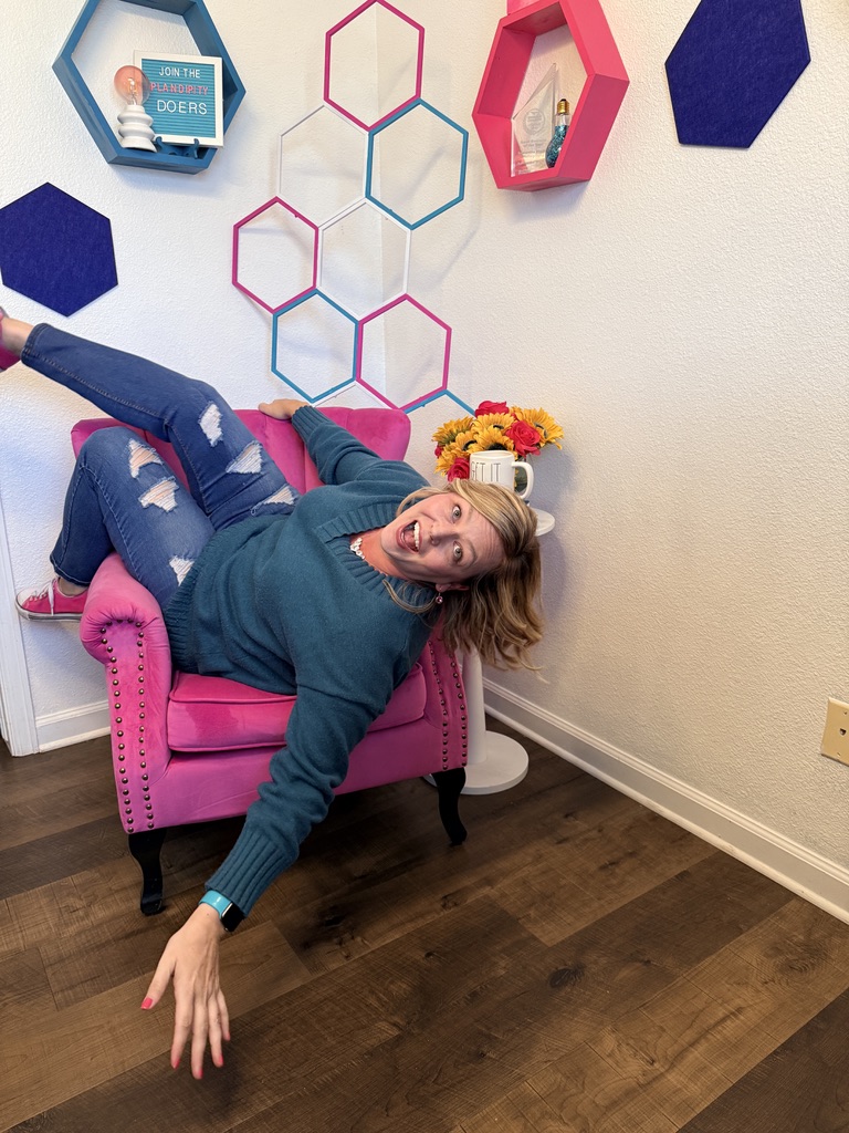 Samantha Markey lounging on pink chair with flowers, Plandipity Doers workspace with hexagonal shelves