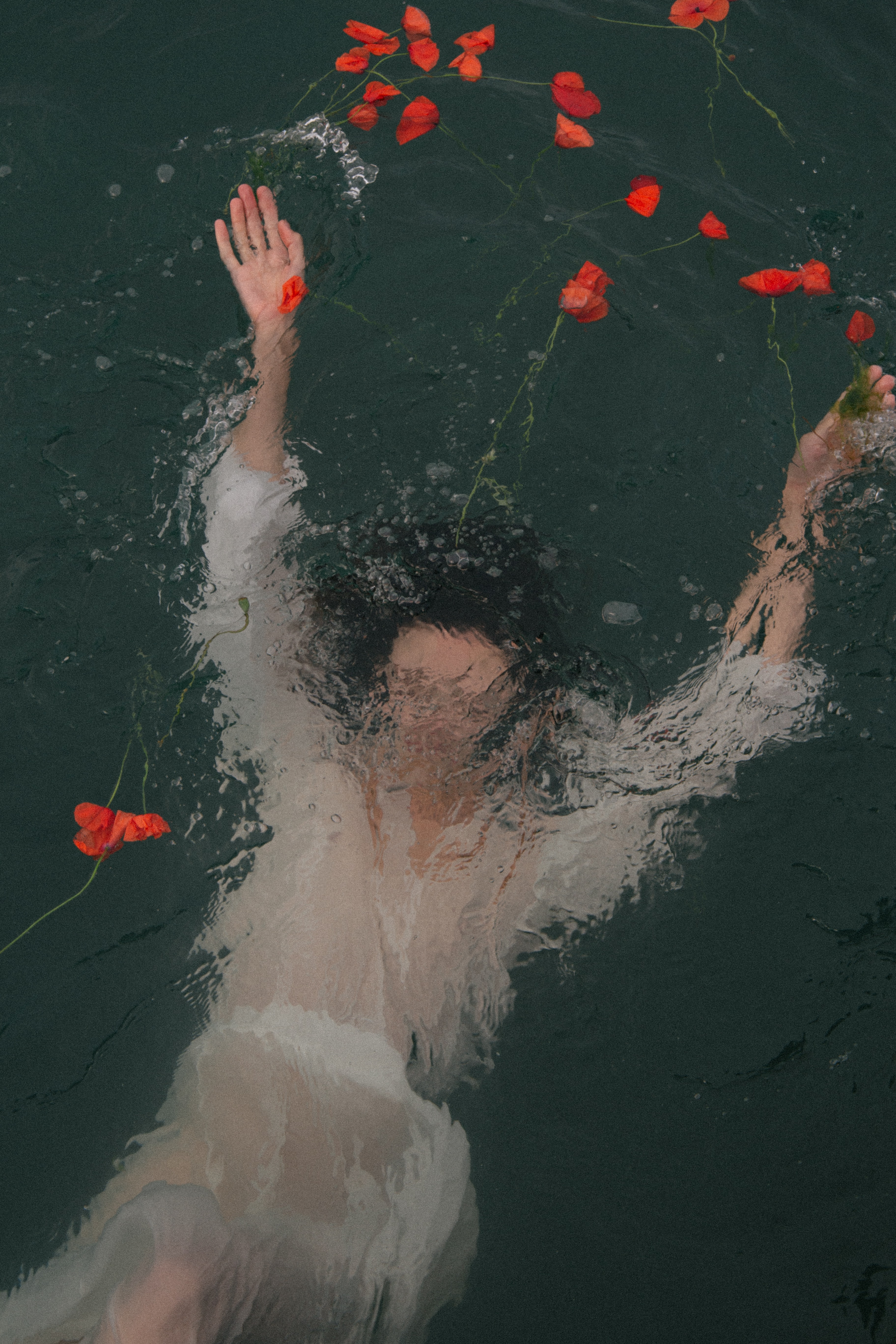 Photo of drowning woman with petals